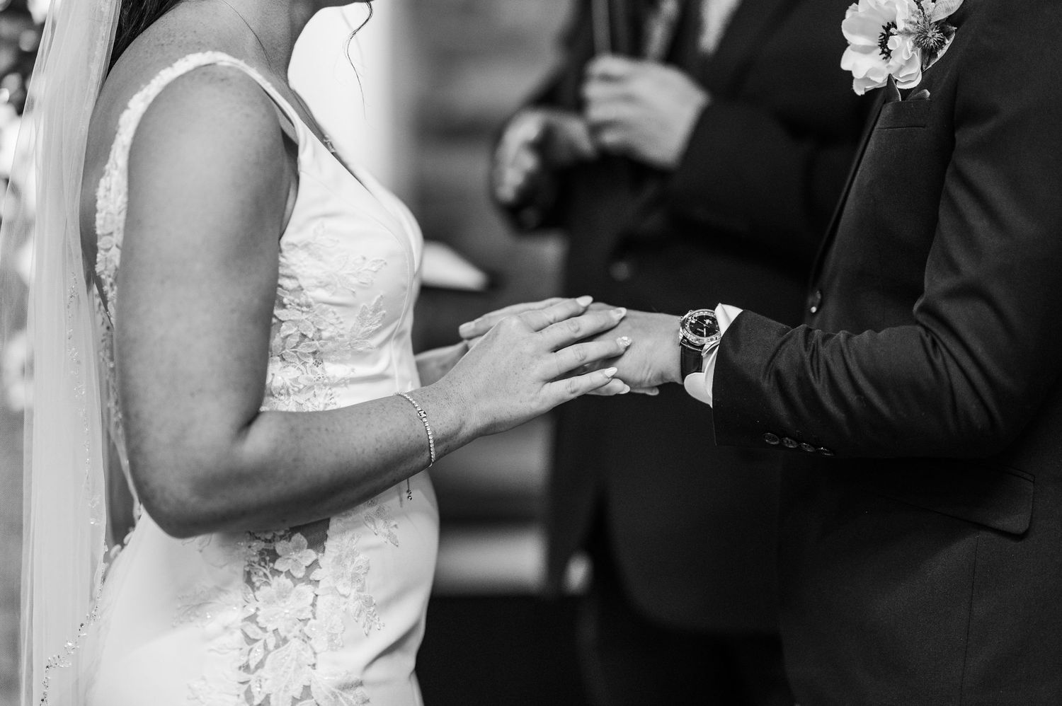 A black and white wedding photo collage showing close-up details of hands exchanging rings during a ceremony.