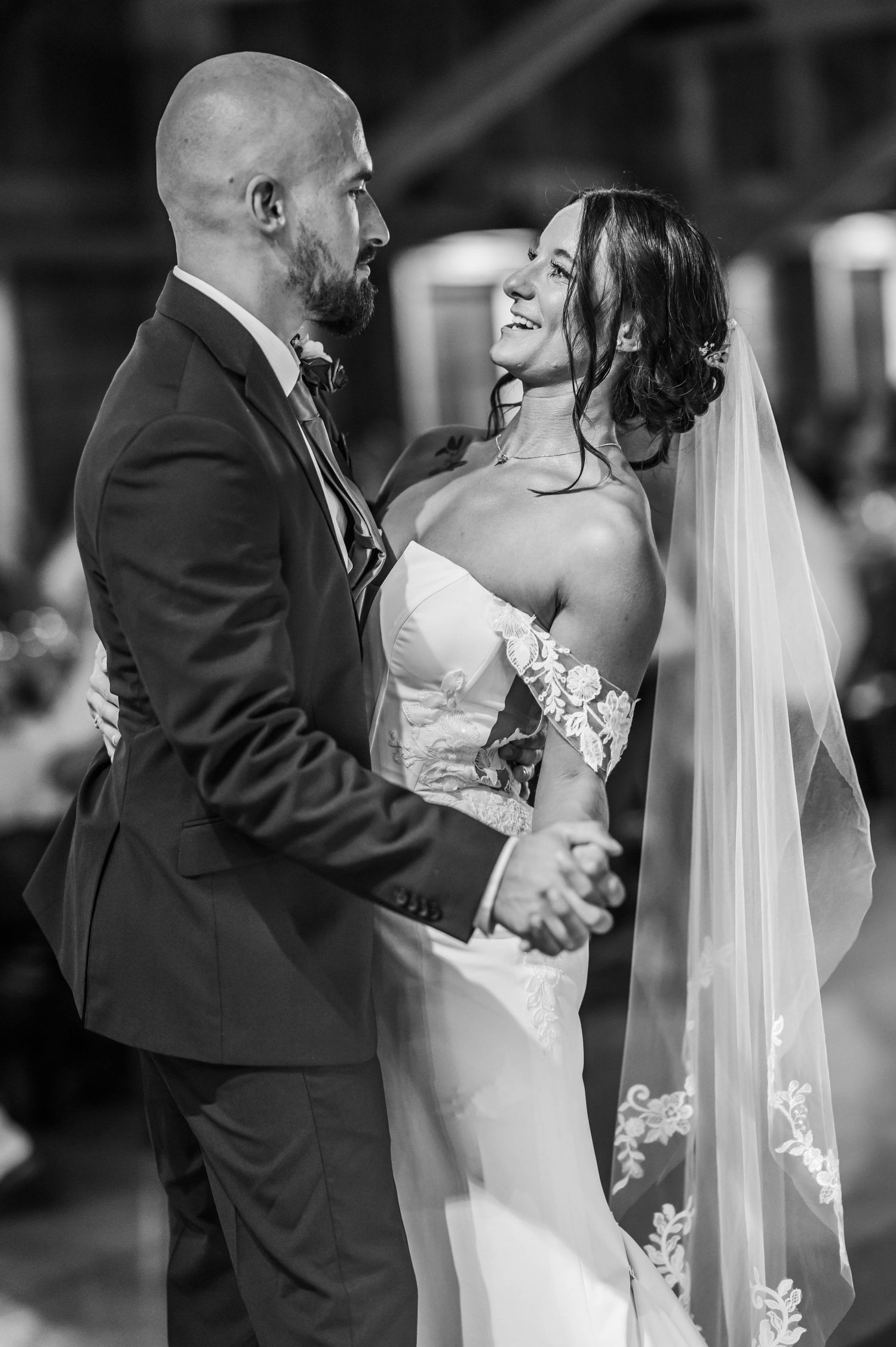A series of romantic black and white wedding photos showing a couple sharing intimate kisses during their ceremony.