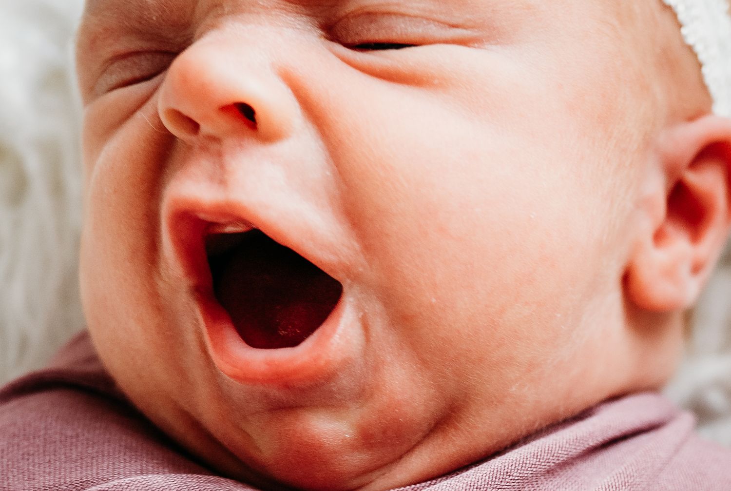 Close-up series of baby facial expressions showing various emotional states from smiling to crying.