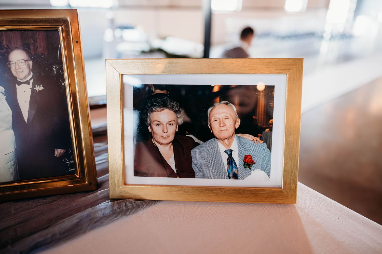 Two framed photographs displayed on a surface with a blurred background.