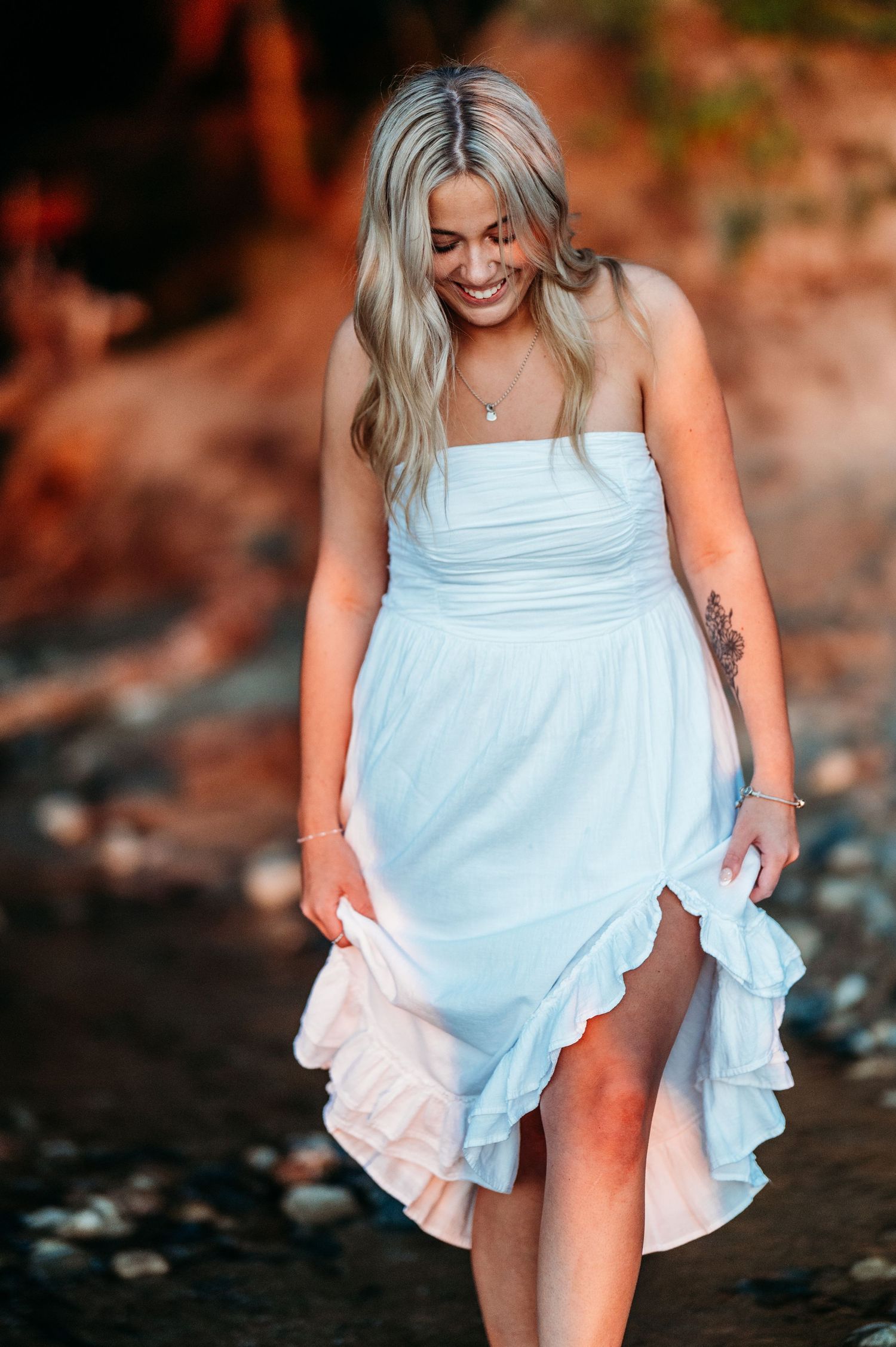 A sequence of photos showing a woman in a light blue ruffled sundress walking along an outdoor setting with warm lighting.