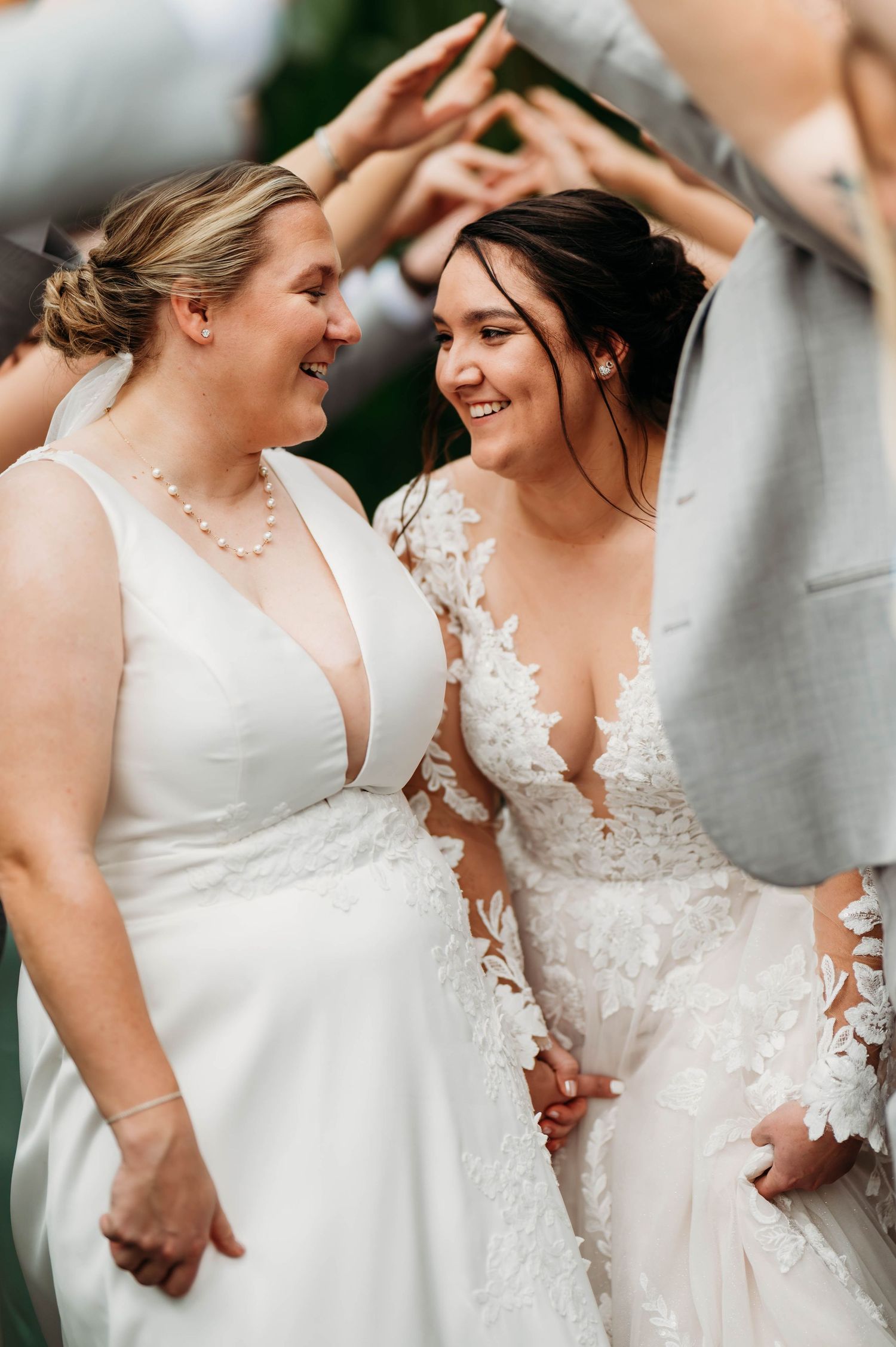 Two wedding dresses shown side by side featuring contrasting styles of white fabric and lace.