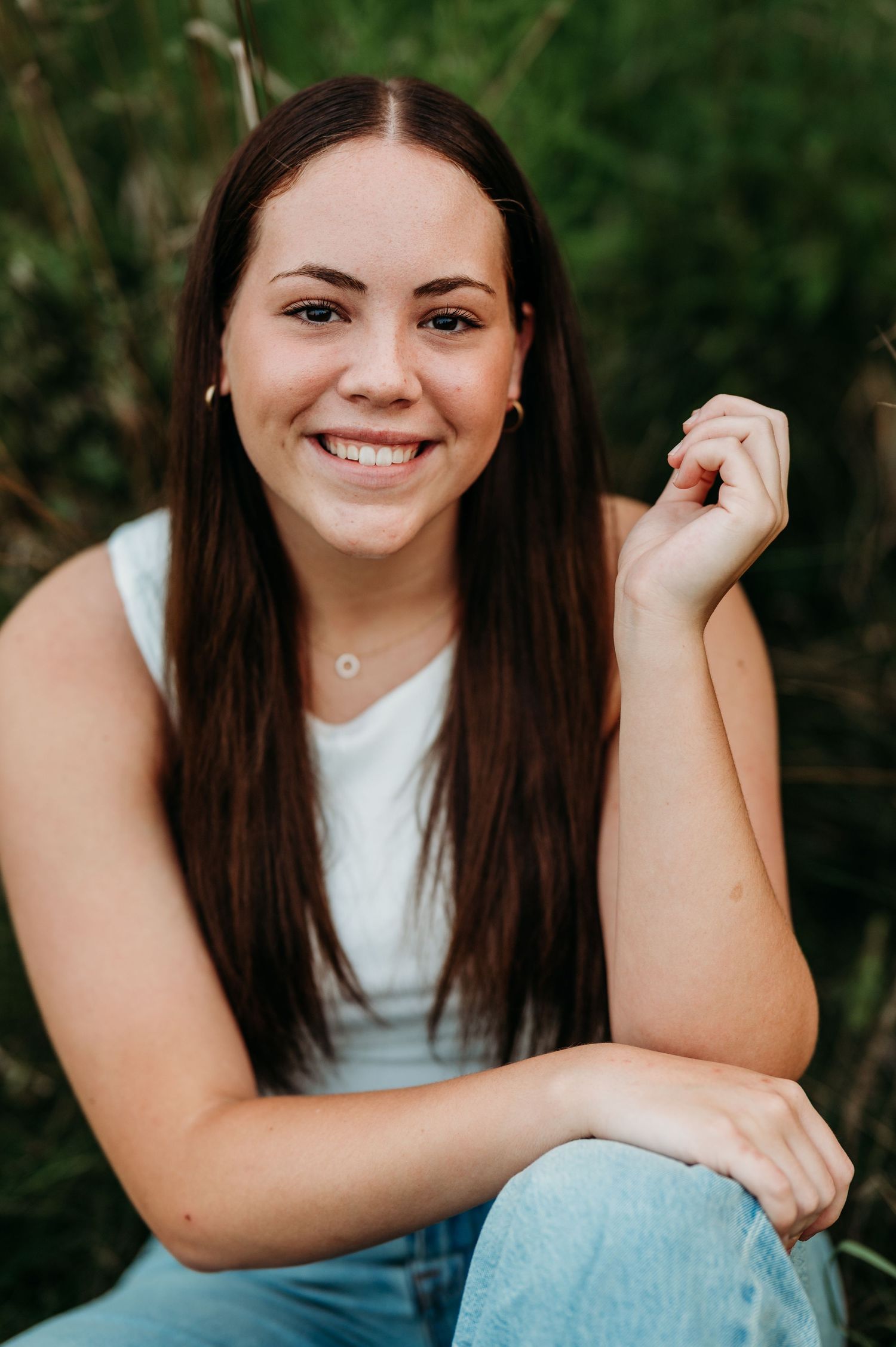 Portrait series showing joyful expressions and casual poses against a natural outdoor background.