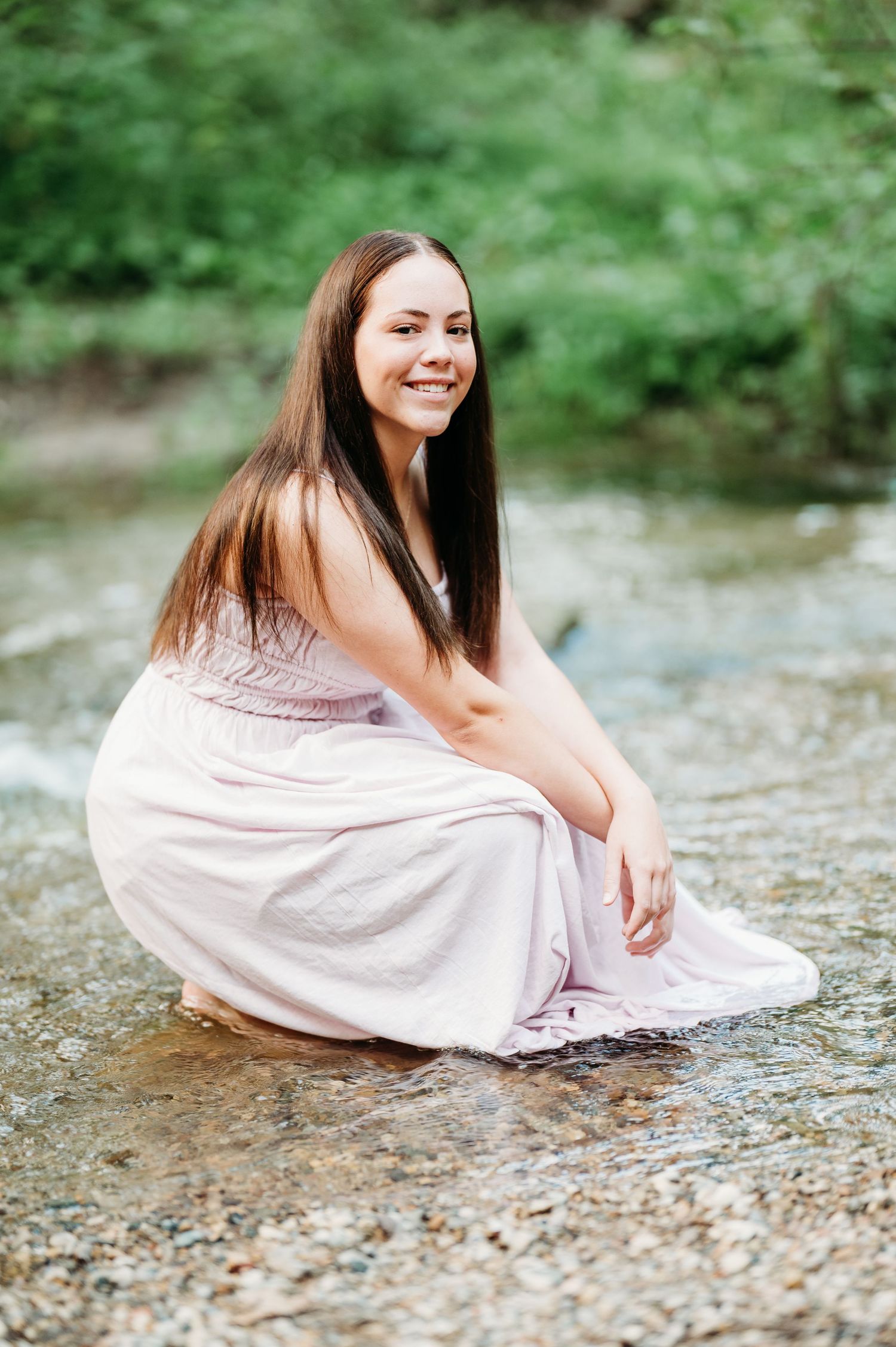 Artistic photo sequence showing relaxed poses by a stream in a light summer dress.