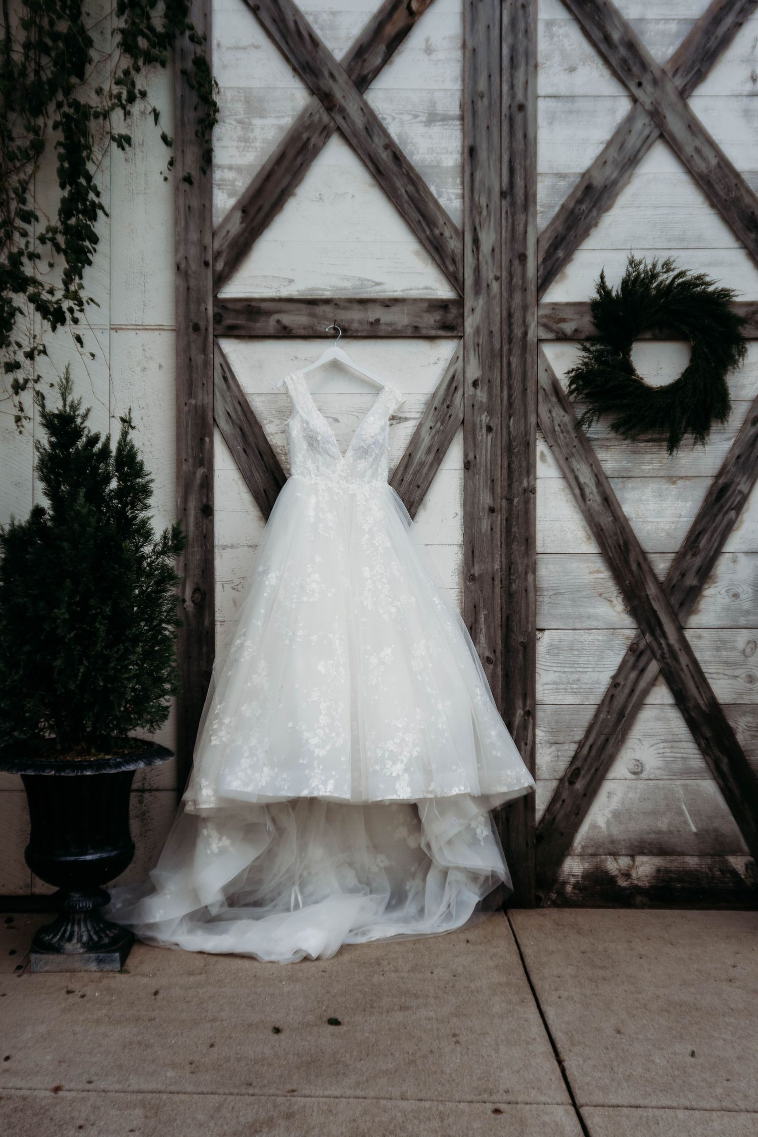 White wedding dress displayed against rustic wooden lattice wall in five similar styled photos.