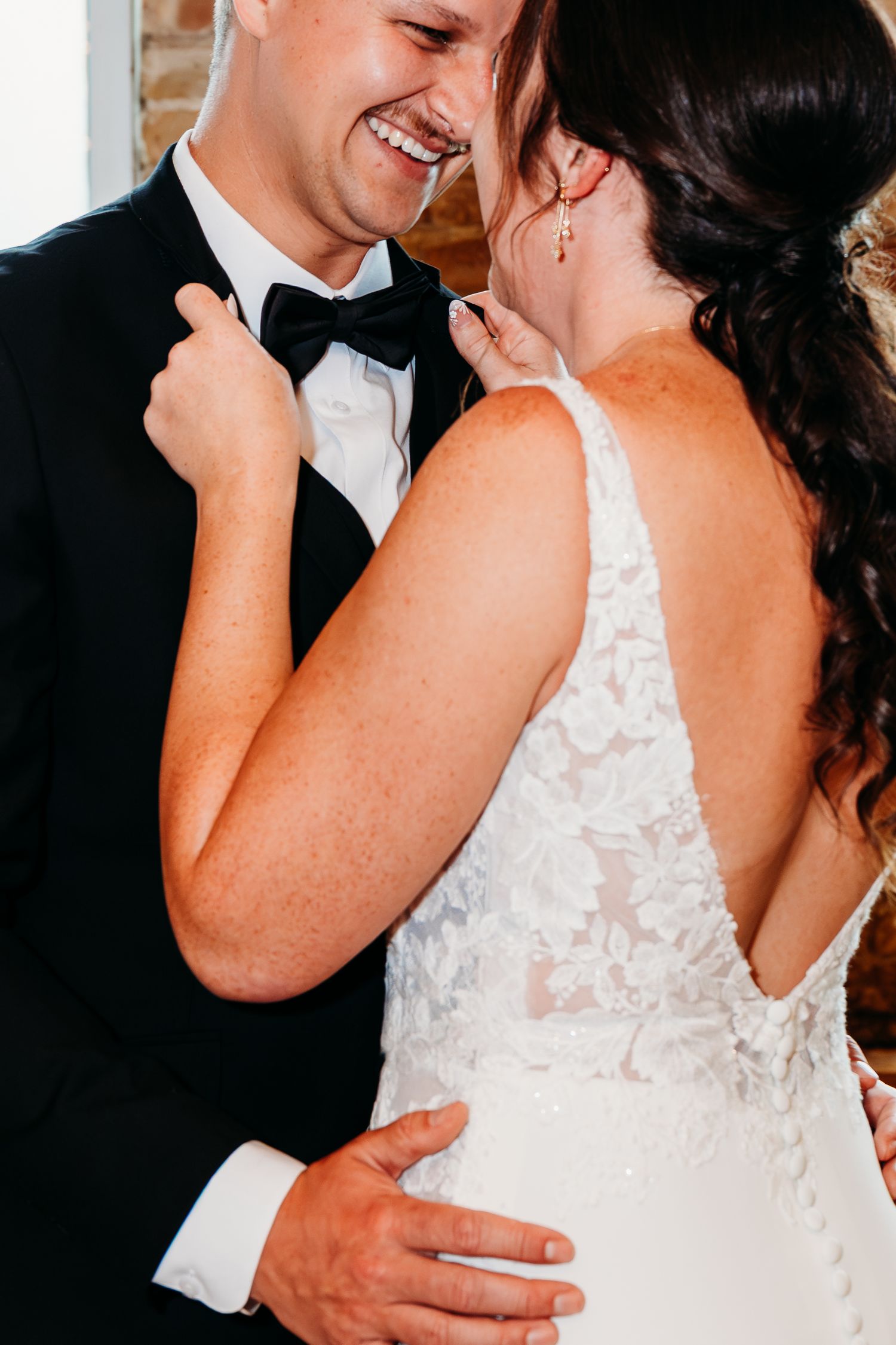 Close-up shots of a couple in wedding attire sharing intimate moments while dancing together.
