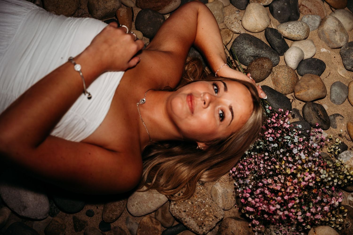 A creative portrait composition with decorative elements on a rustic wooden surface.
