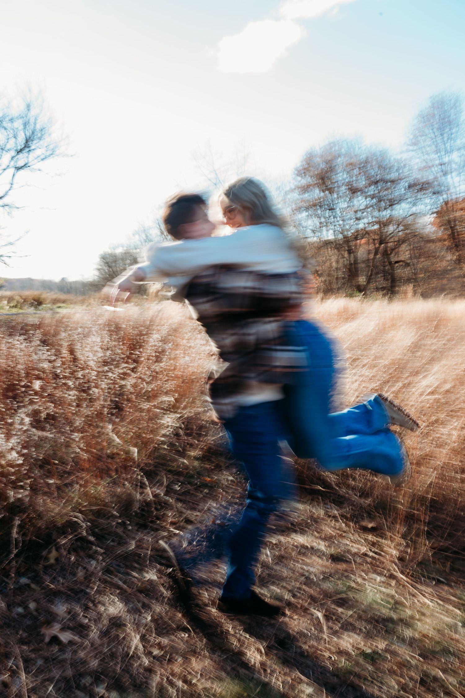 Motion blur sequence shows playful spinning dance moves in a golden field during sunset.