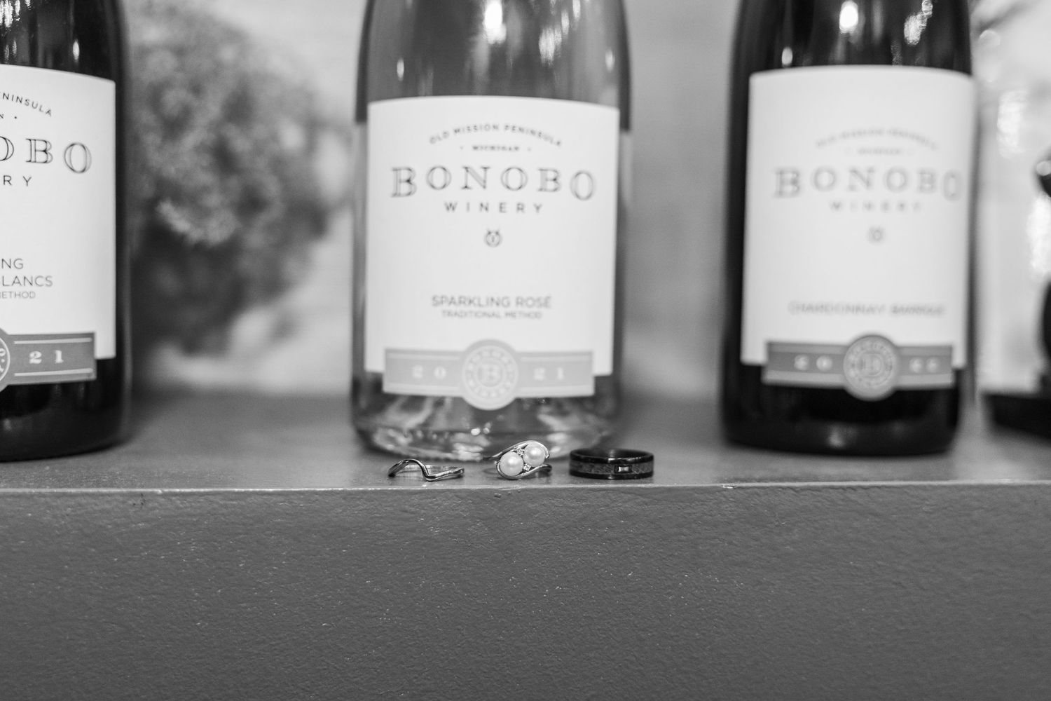 Black and white image of wine bottles lined up on a shelf showing Bondho wine labels.