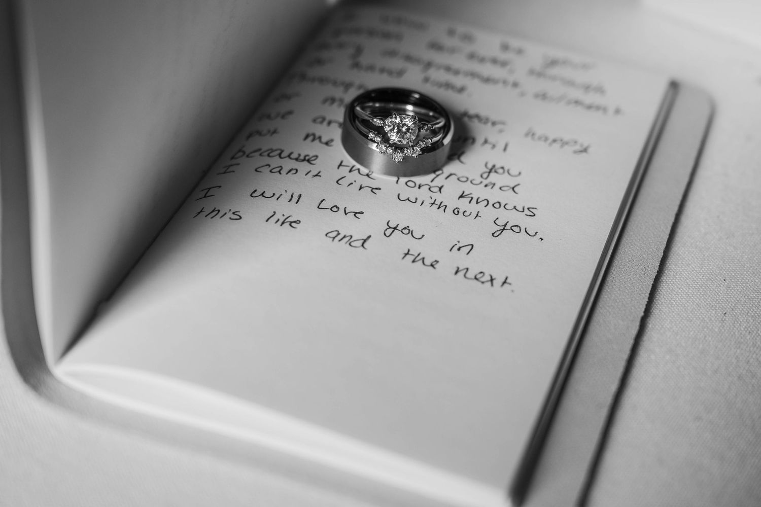 A close-up view of handwritten text in a notebook with a pen visible in the frame.