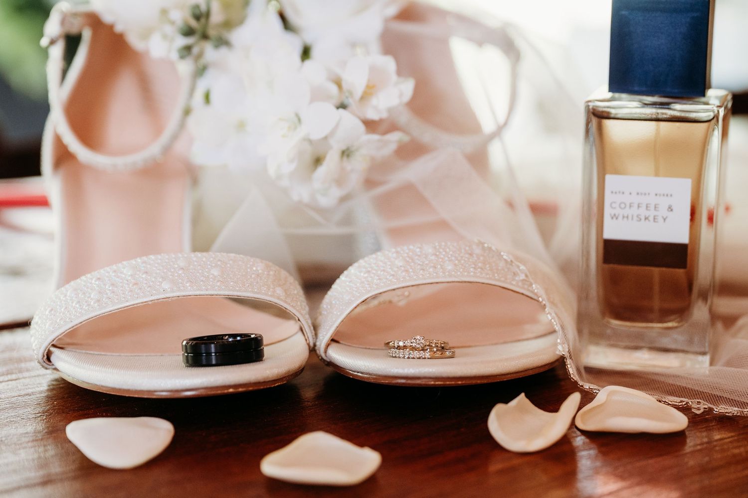 A collection of spa skincare and beauty products arranged on a white surface with pink lighting and reflections.