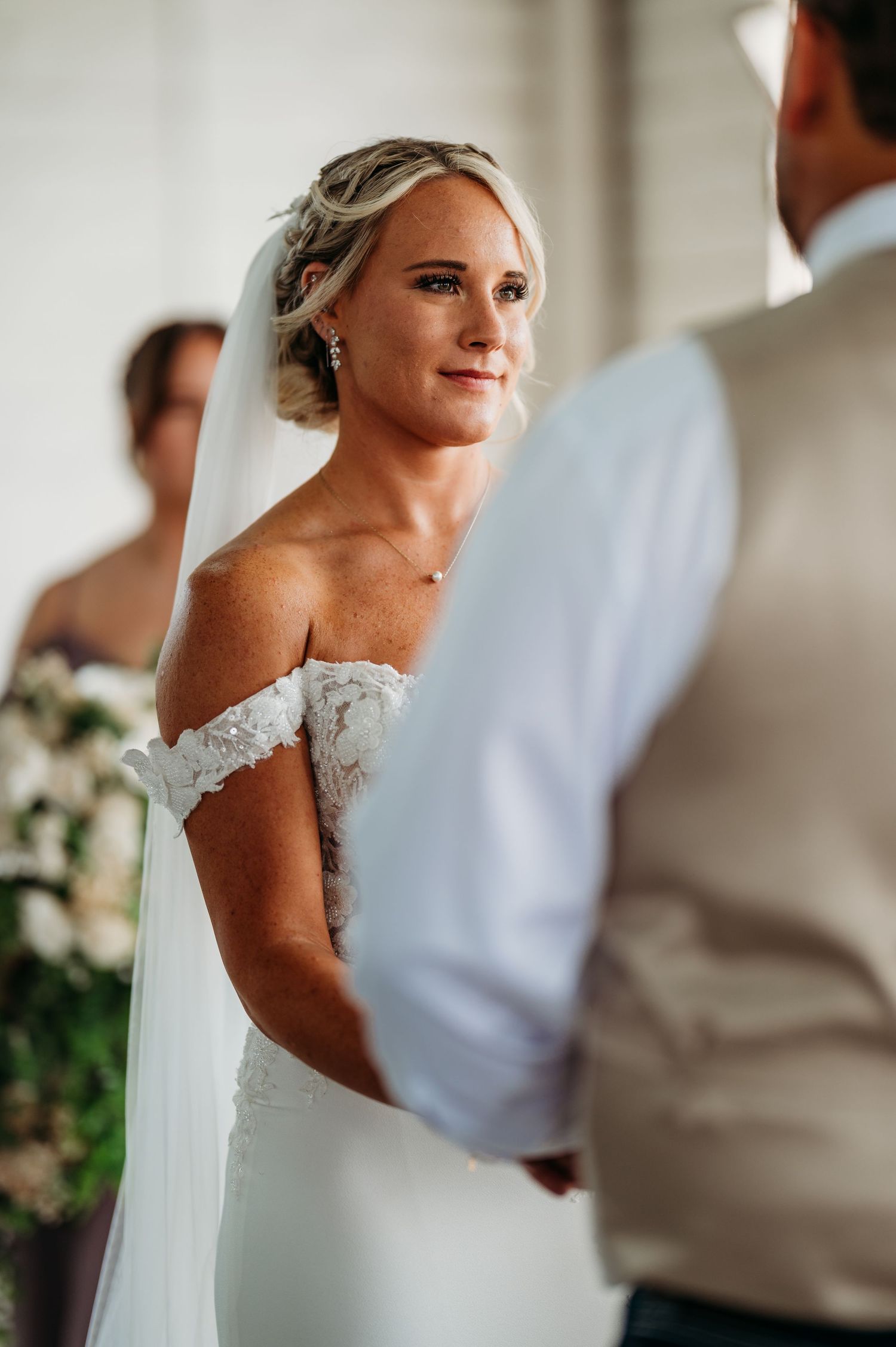 Close-up shots of a bride in an elegant lace wedding dress with delicate details and flowing veil.