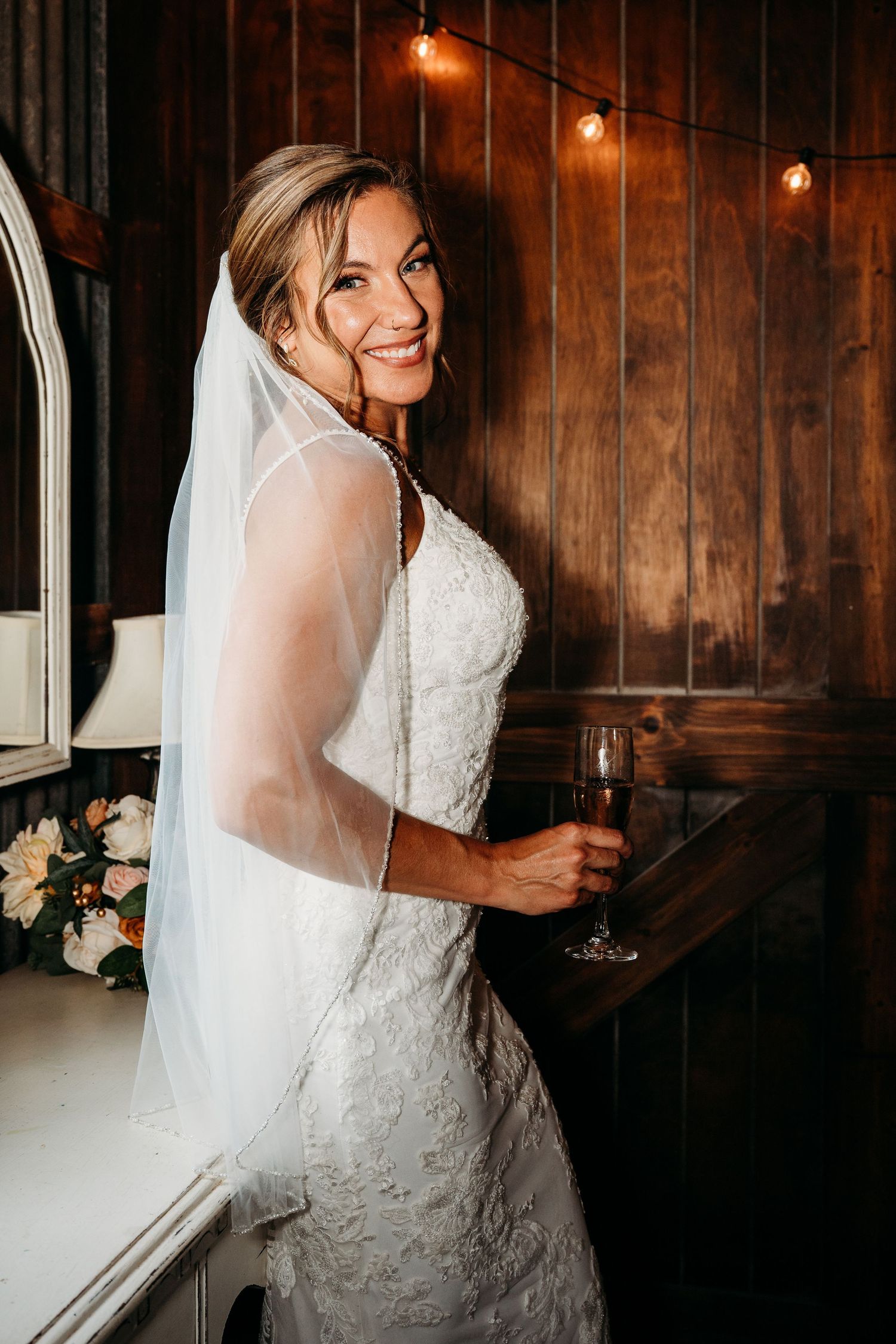 Candid bridal portraits in a rustic wooden venue with warm lighting and vintage ambiance.