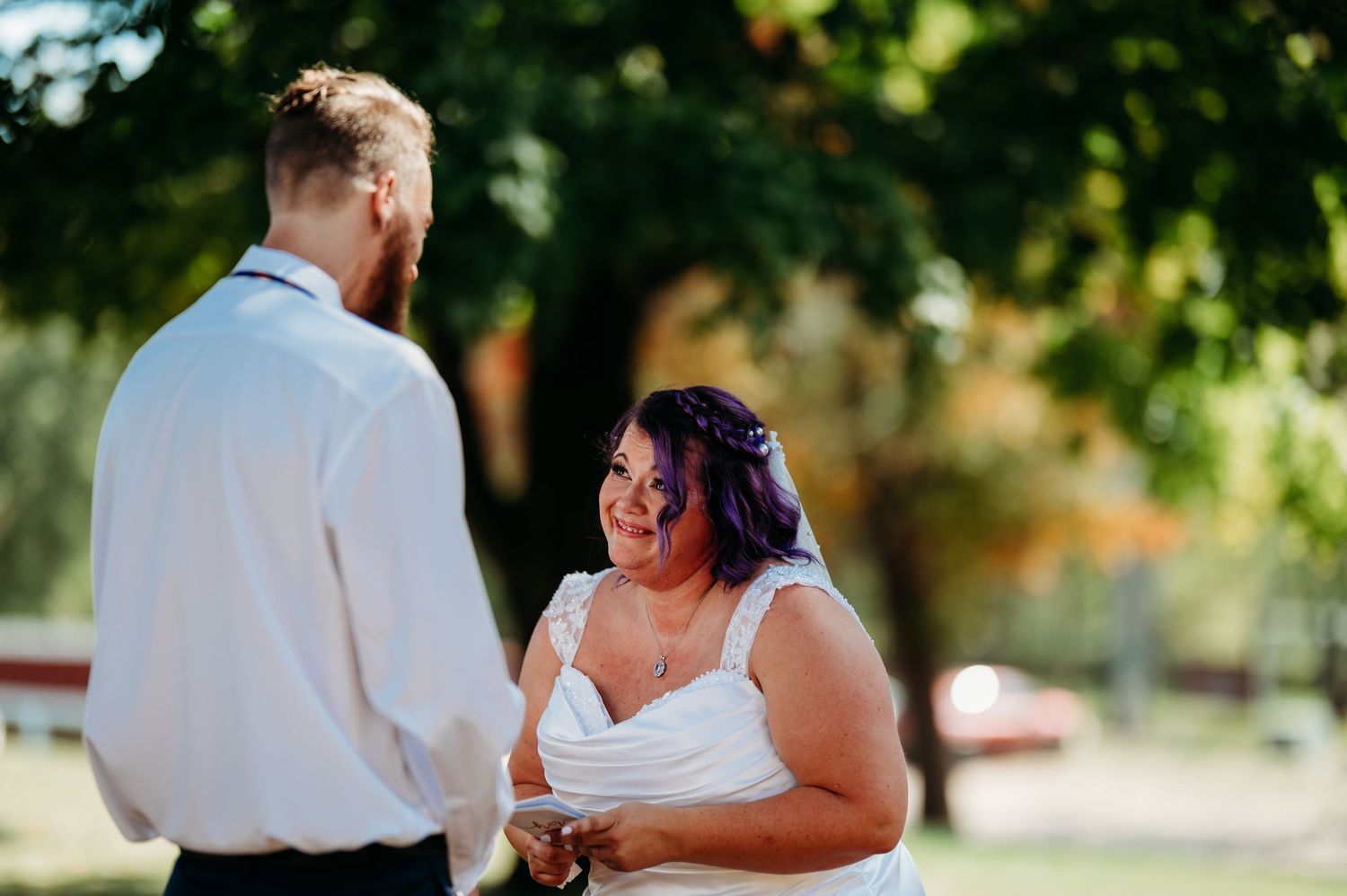 Bride and groom share a romantic dance outdoors during their wedding reception.