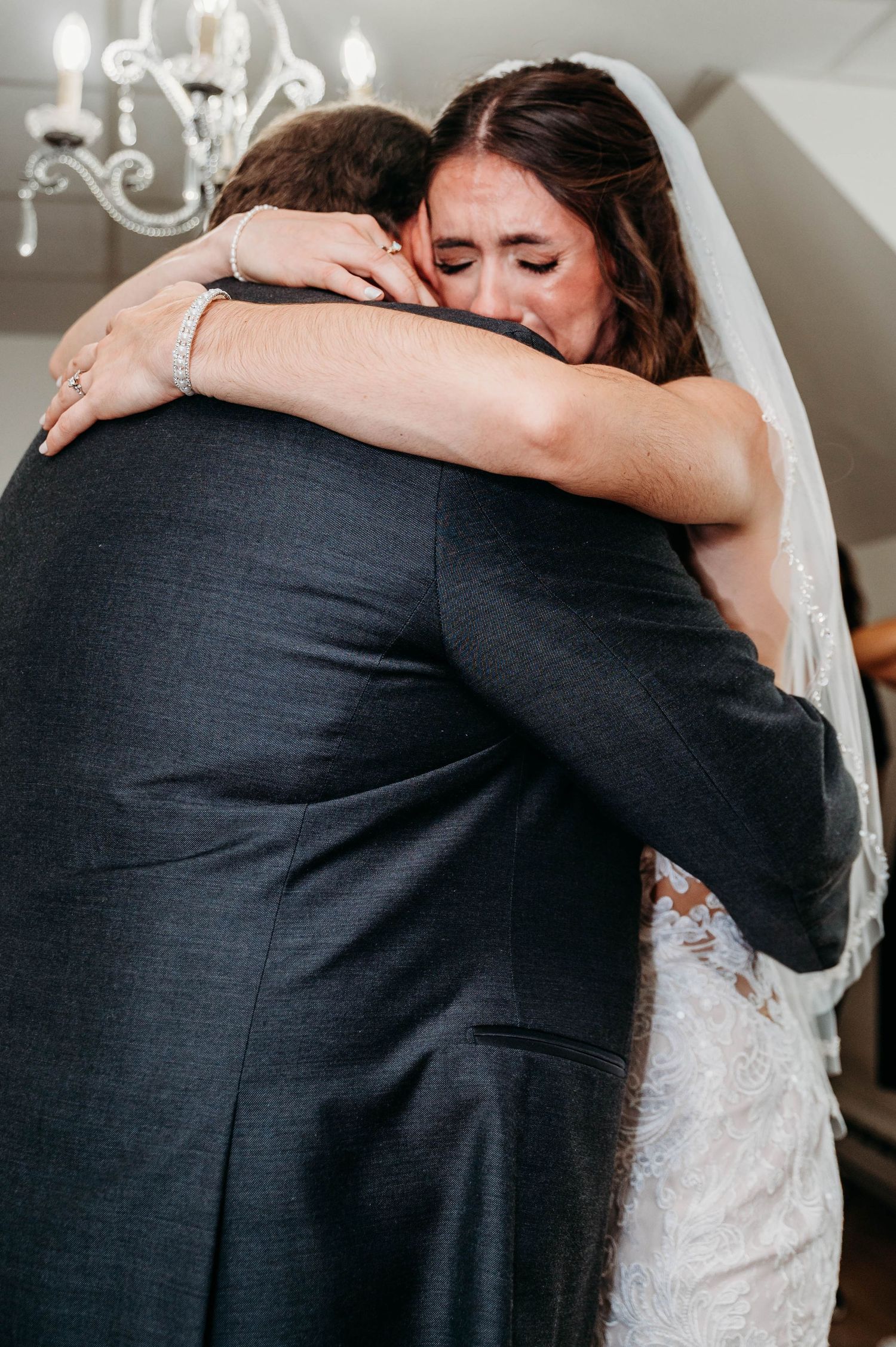 Close-up sequence showing an emotional embrace between two people during a wedding celebration.