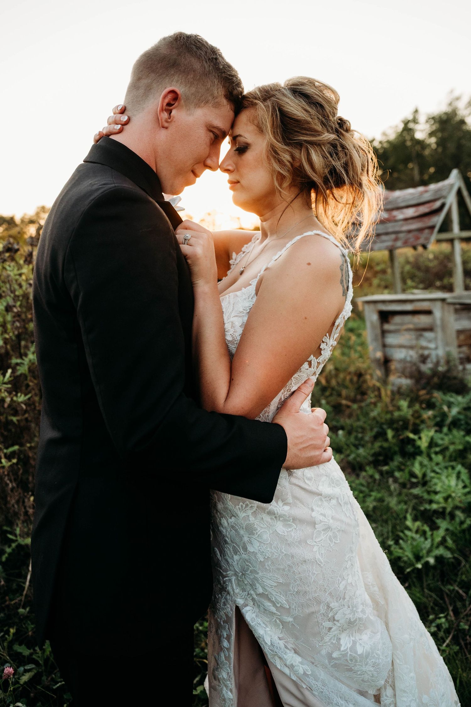 Intimate sunset portrait of newlyweds in a garden setting.