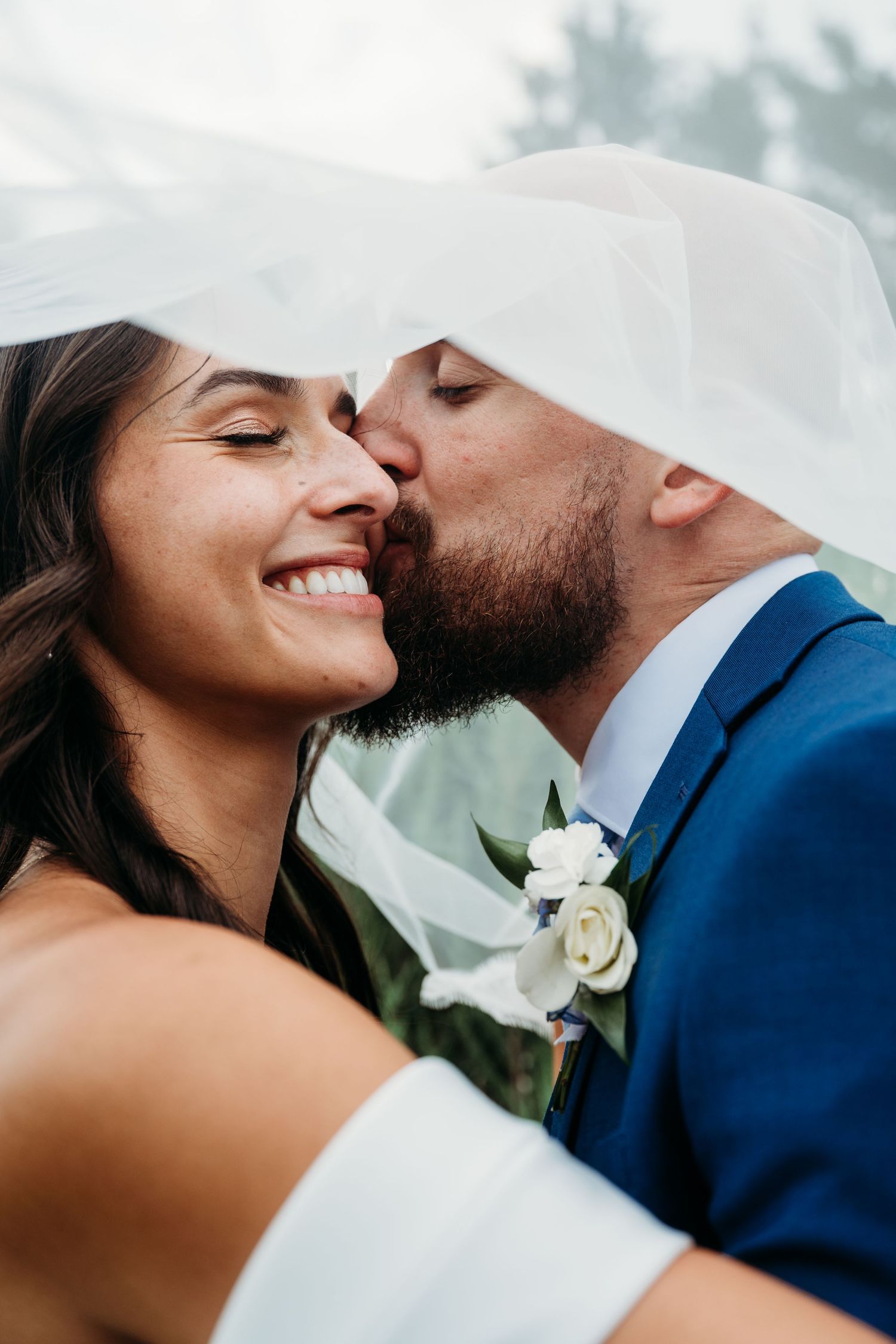 Close-up romantic photos of a bride and groom sharing tender kisses against a soft bokeh background.