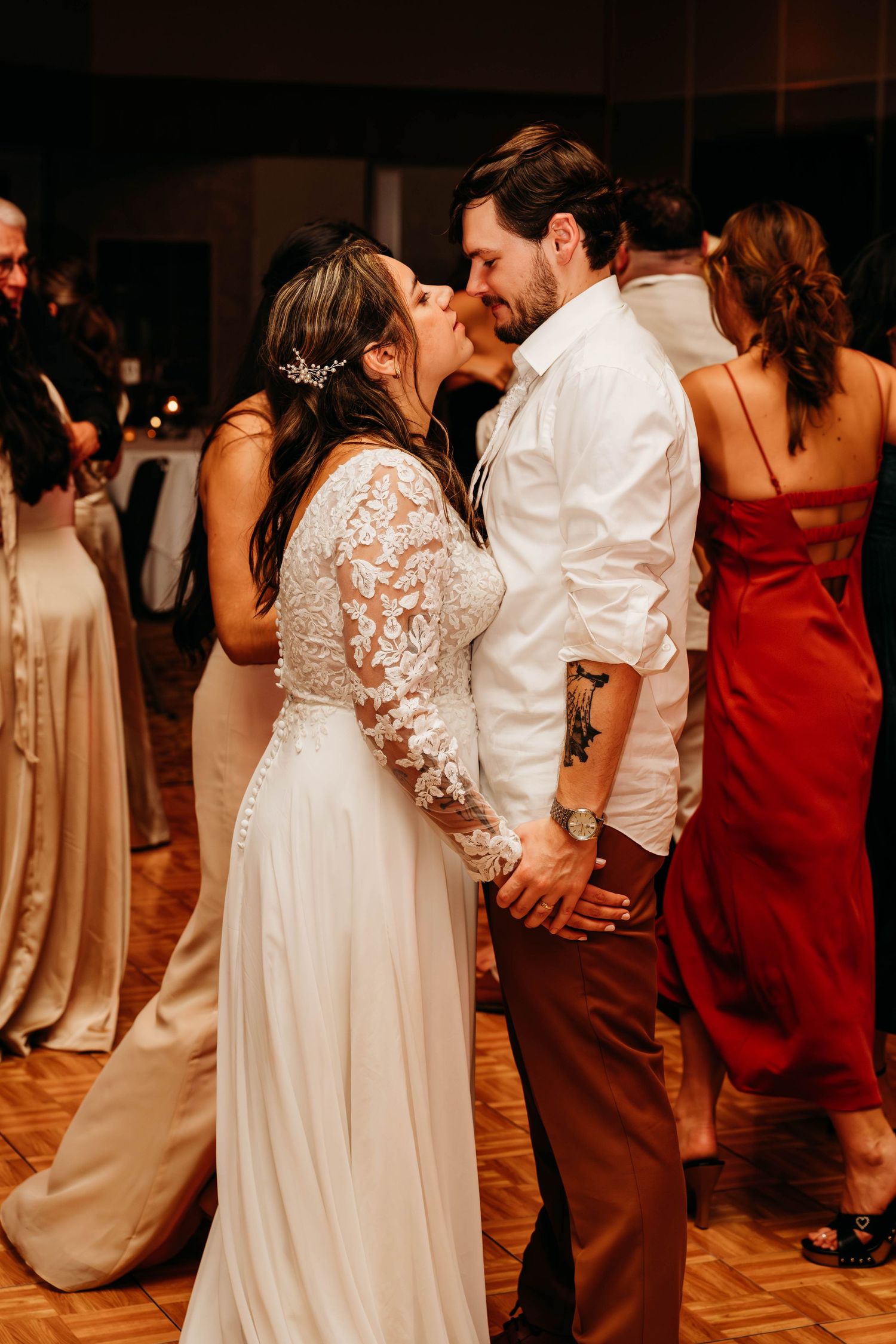 Couples dance together at an elegant wedding reception with burgundy and white color scheme.