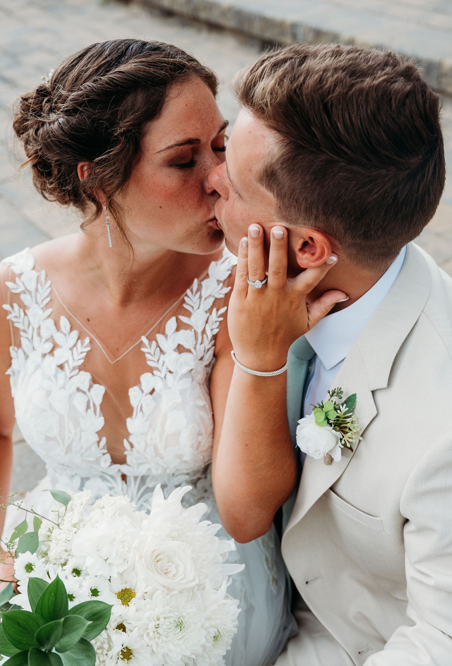 A series of romantic wedding photos showing intimate kisses between a couple in white wedding attire with floral details.
