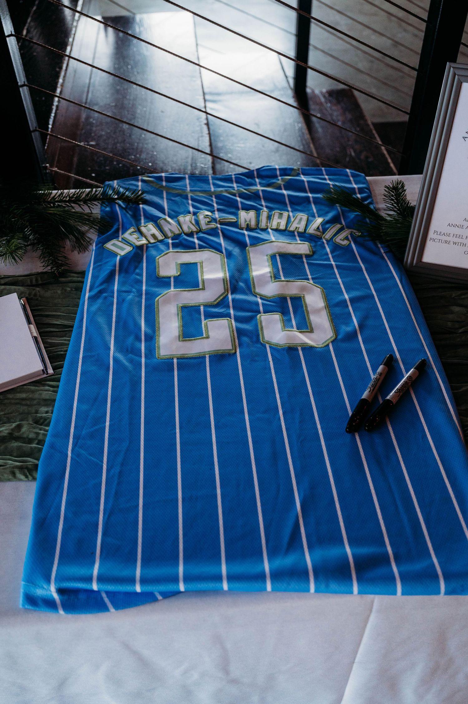 Blue and white striped jersey with number 20 laid out flat on display.