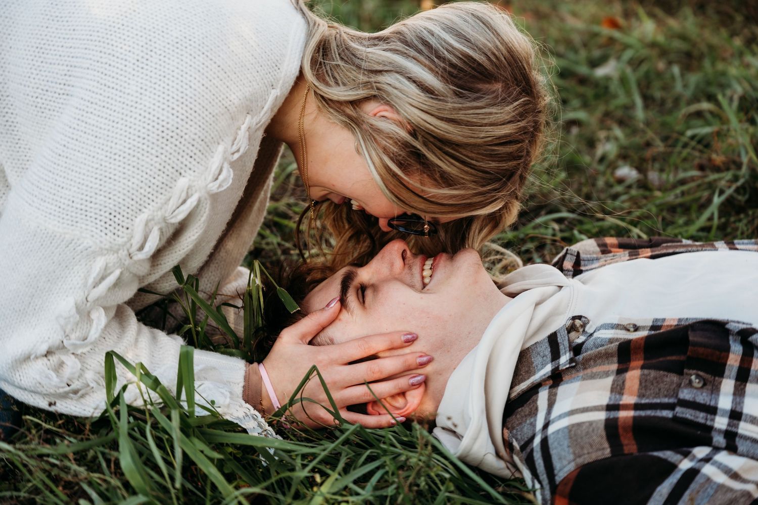 A series of overlapping photos showing a person lying in grass while wearing a white shirt and plaid pants.