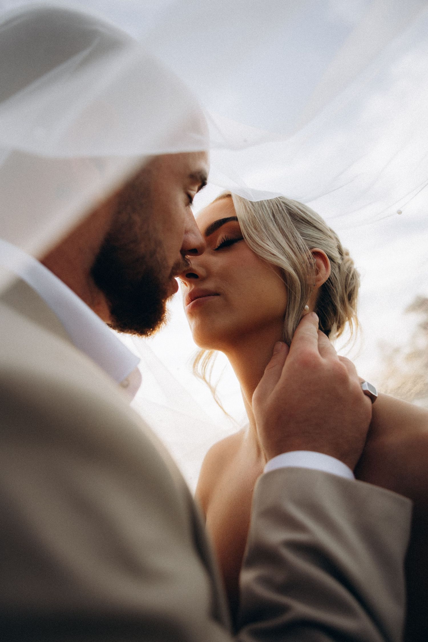 An intimate close-up of a couple sharing a romantic moment outdoors.