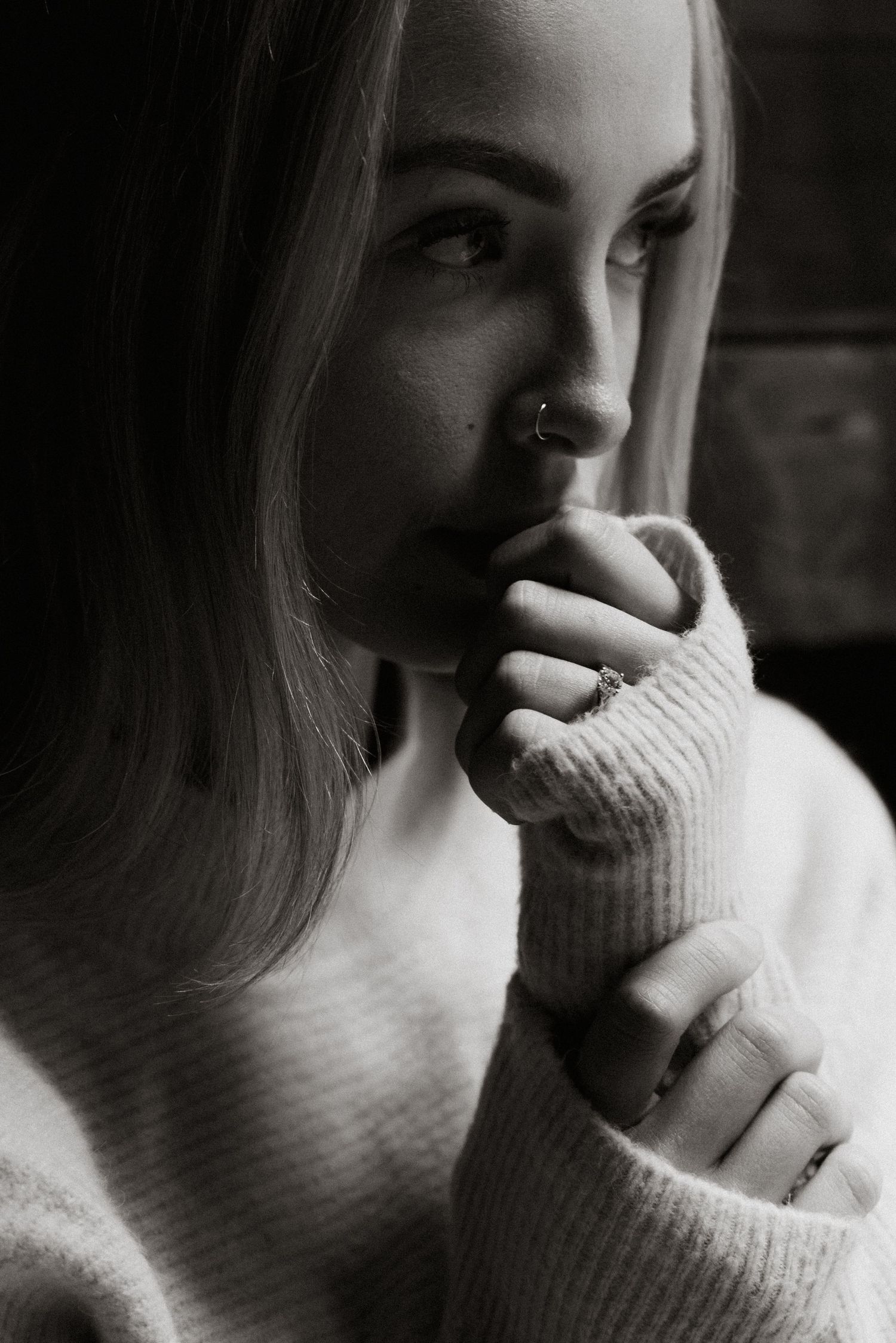 Intimate close-up series showing thoughtful expressions in dramatic lighting.