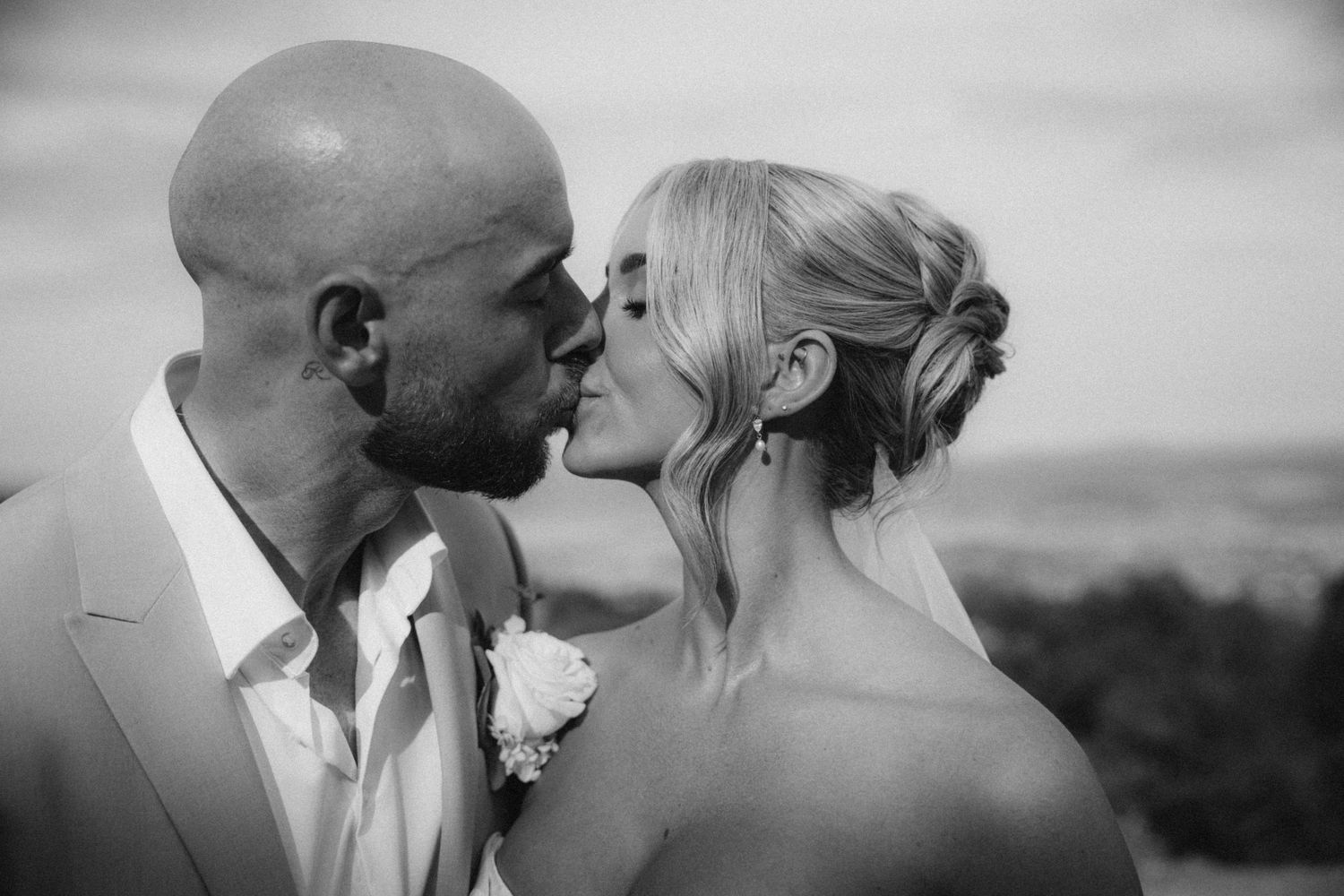 Black and white romantic wedding portraits captured against natural landscape.
