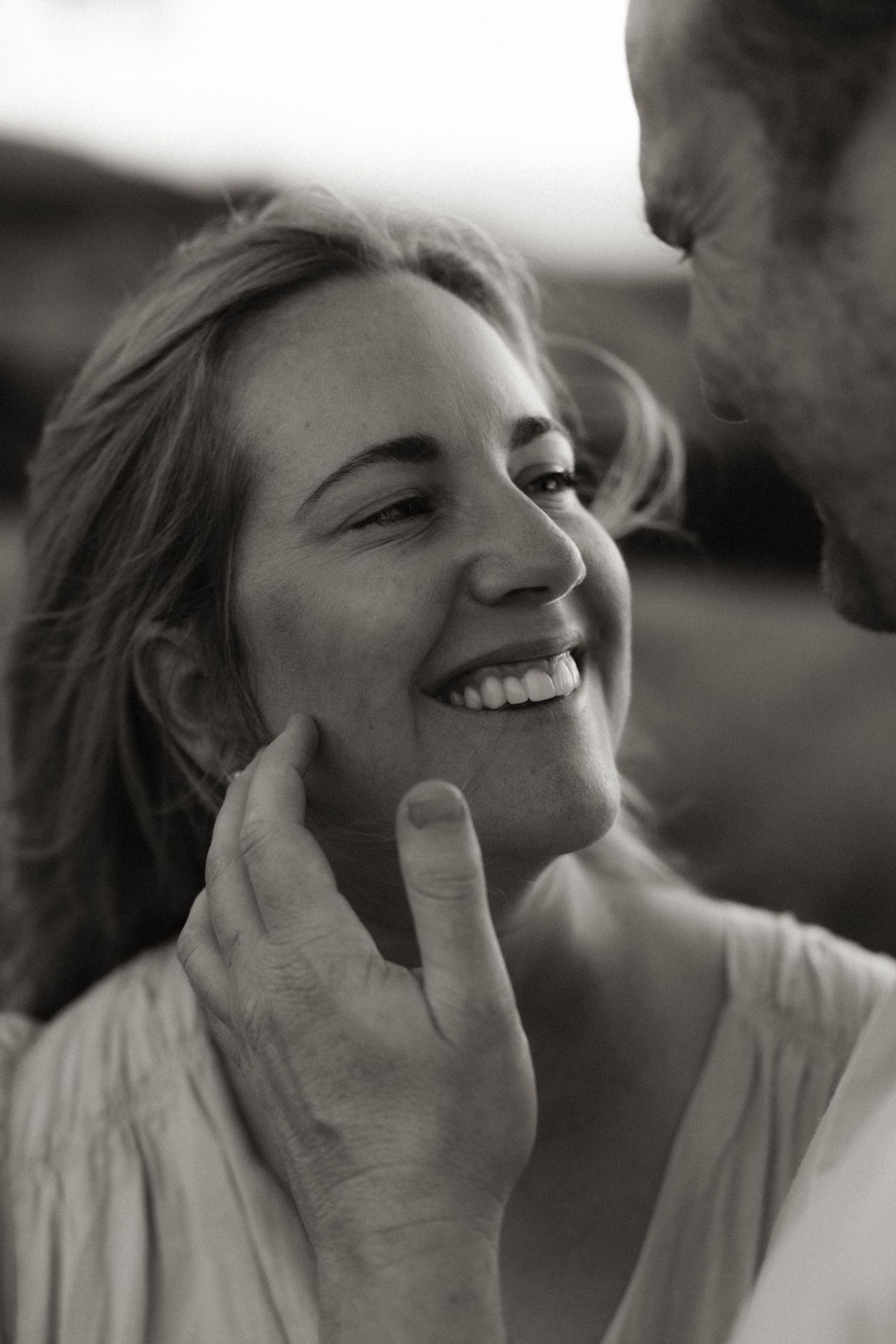 Black and white portrait series showing joyful laughter and genuine emotions.