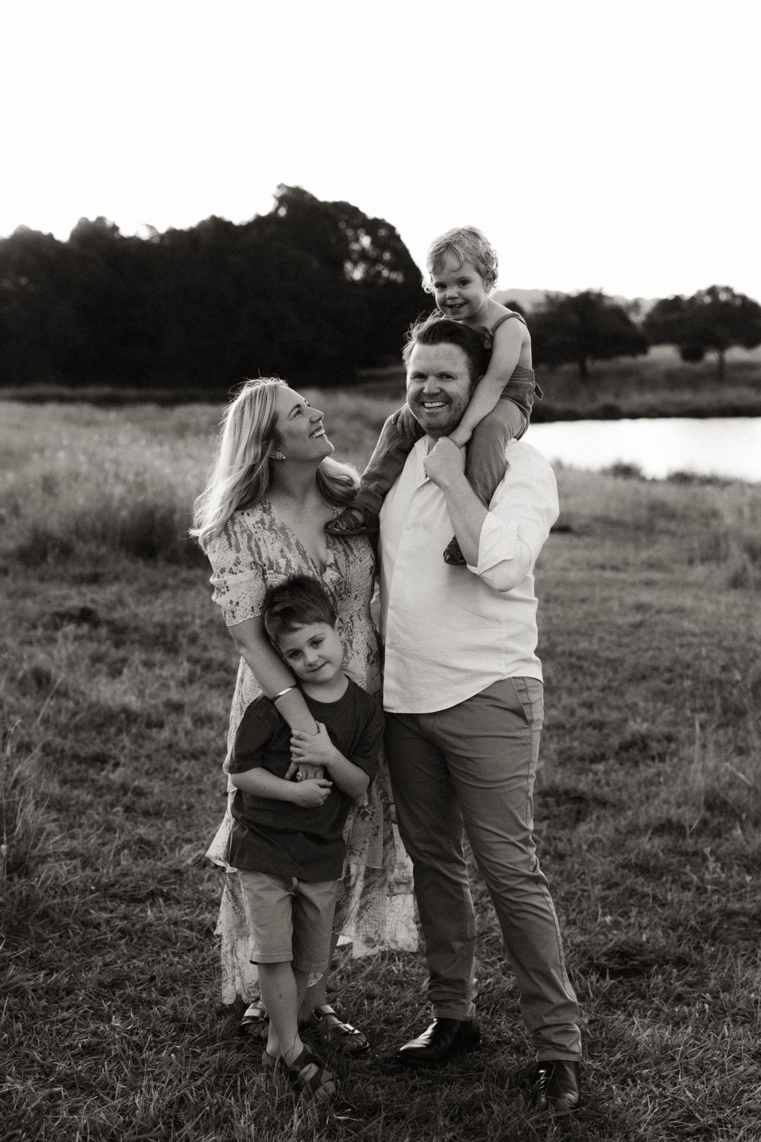 Black and white series of family embraces in an outdoor setting.