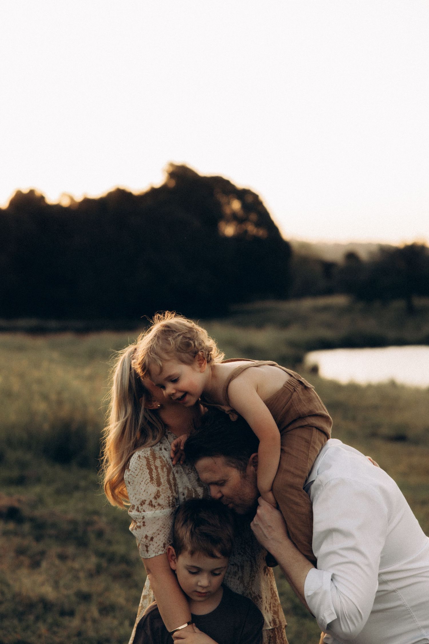 Candid family photos showing affectionate interactions at sunset.