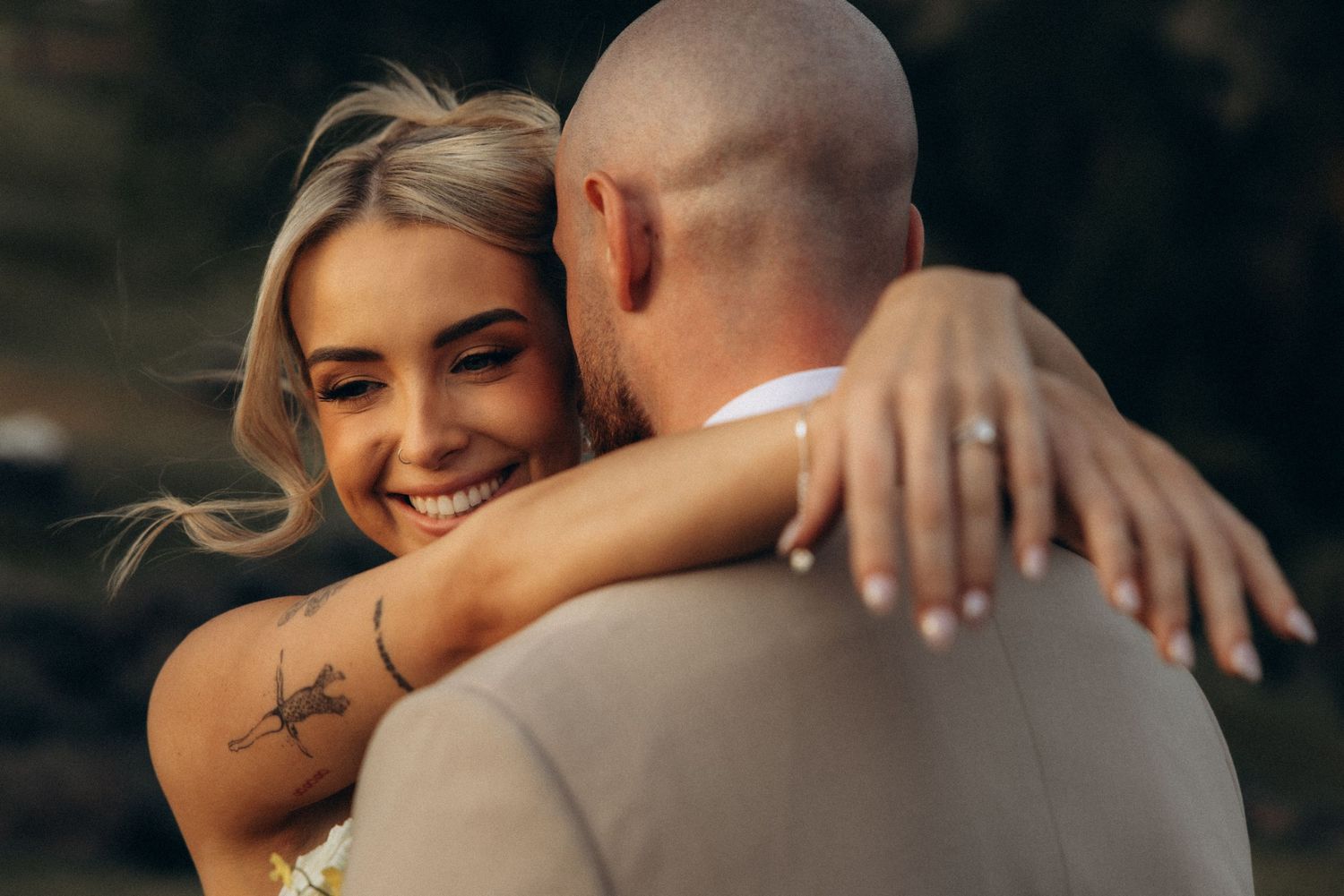 A tender moment between a couple in formal wedding attire.
