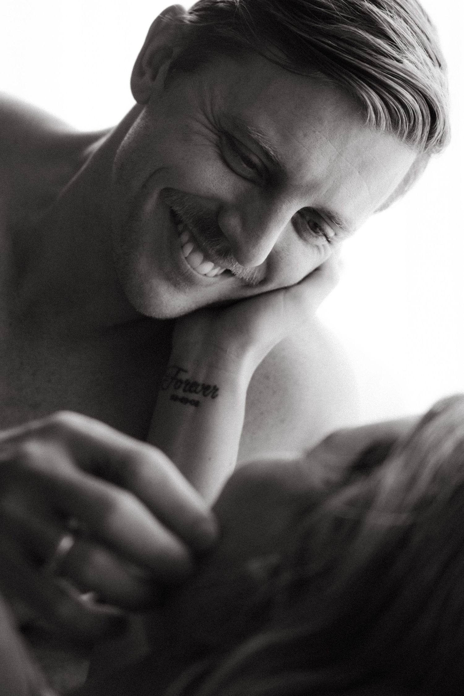 Artistic black and white portrait showing soft focus and intimate angles.
