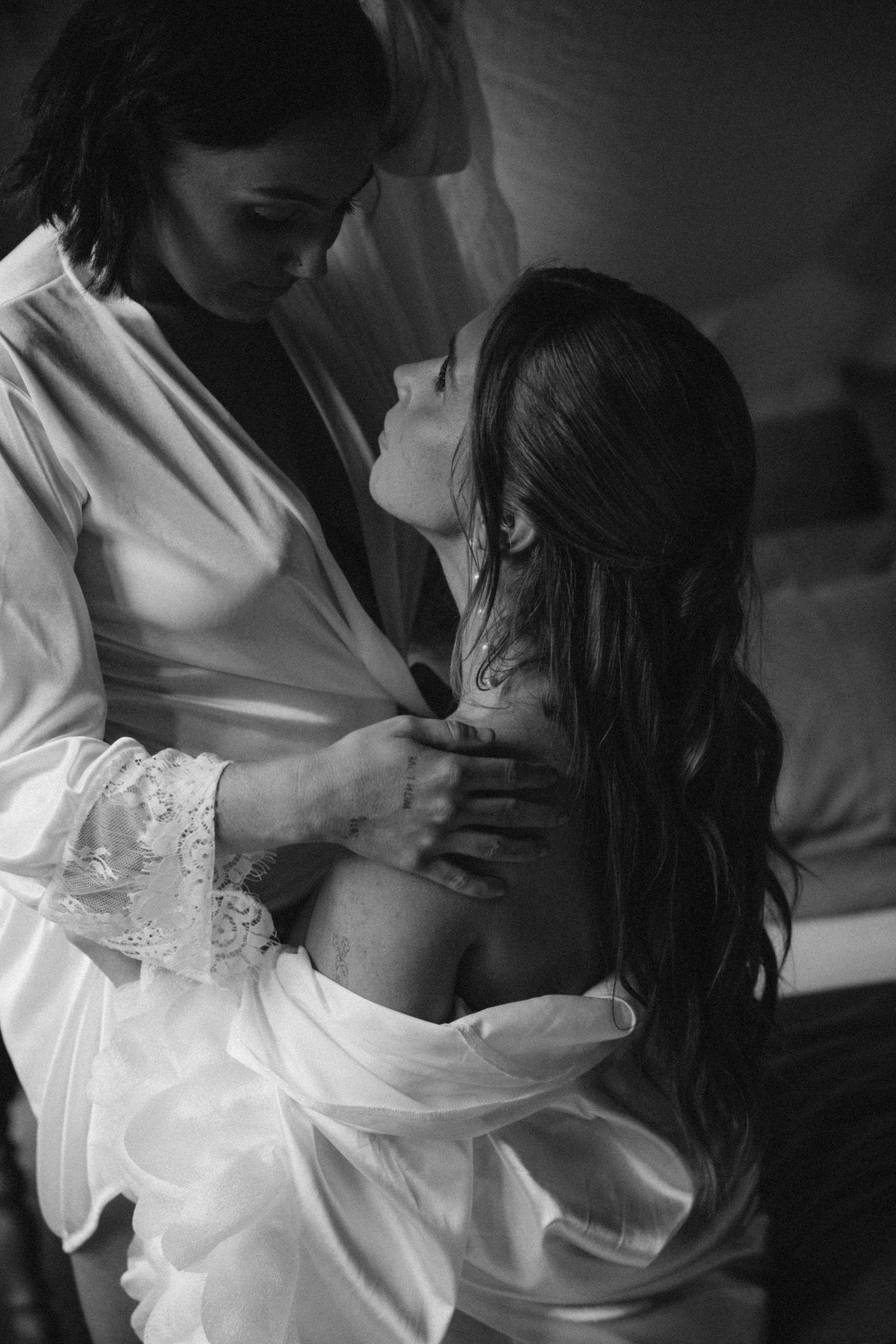 Intimate black and white photos showing tender moments between two people.
