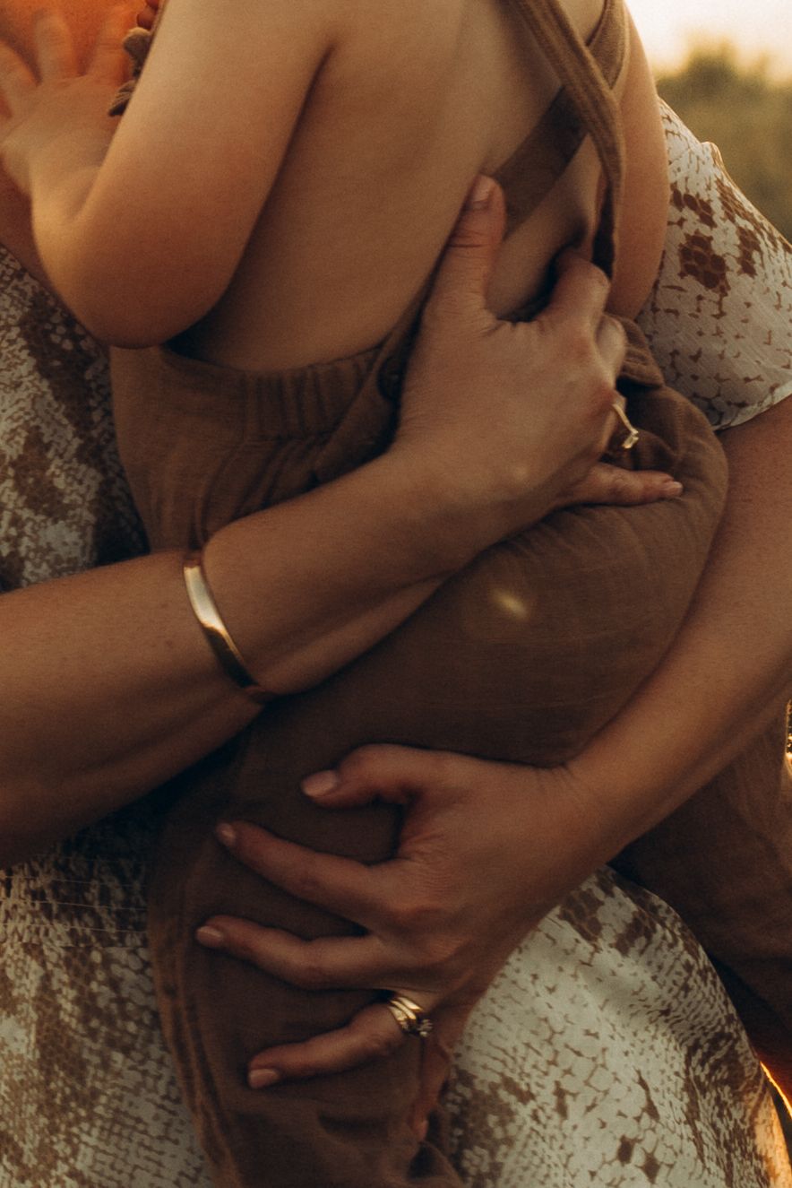 Close-up intimate portrait showing gentle embraces in warm lighting.