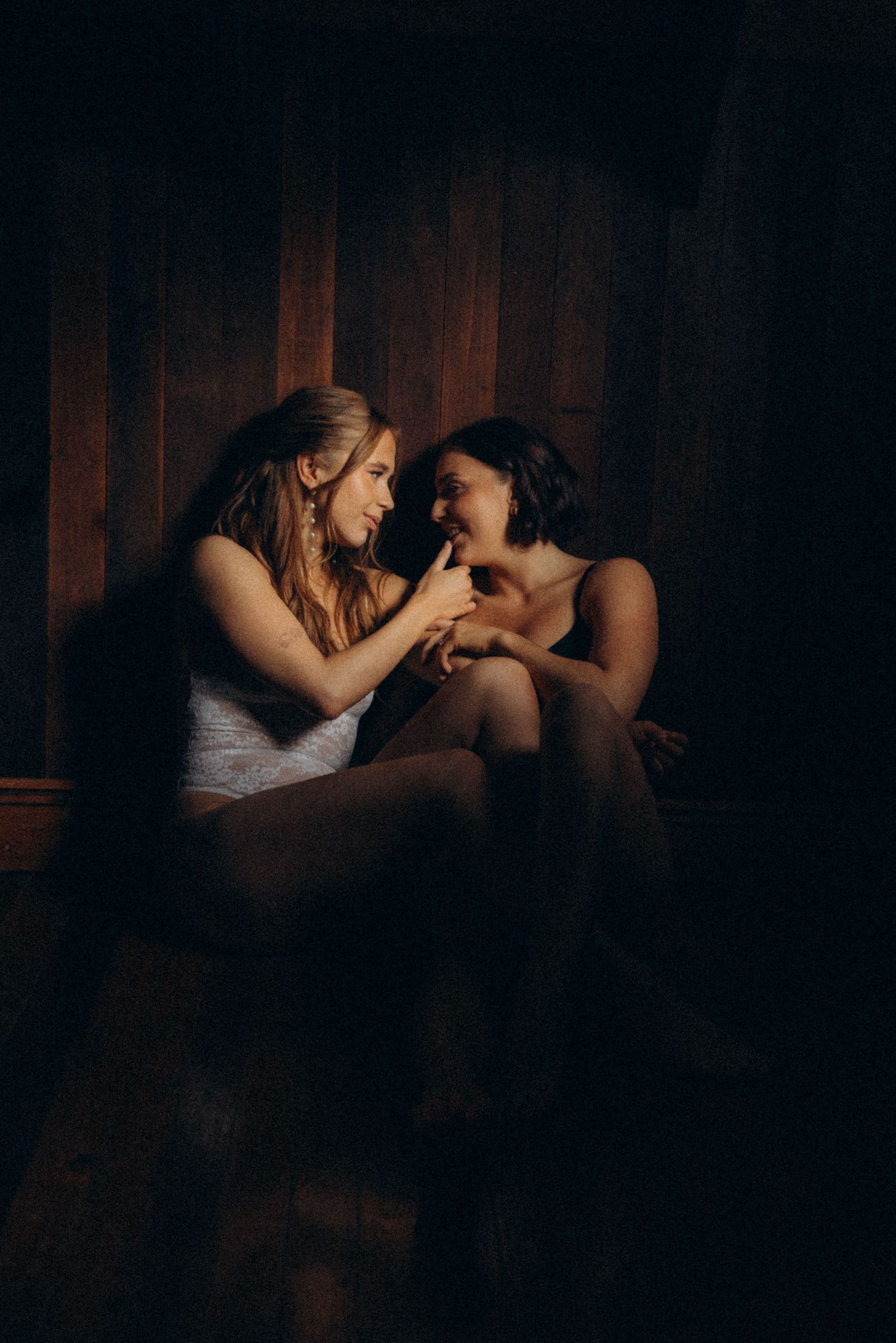 Intimate low-light portraits showing tender moments between two people.
