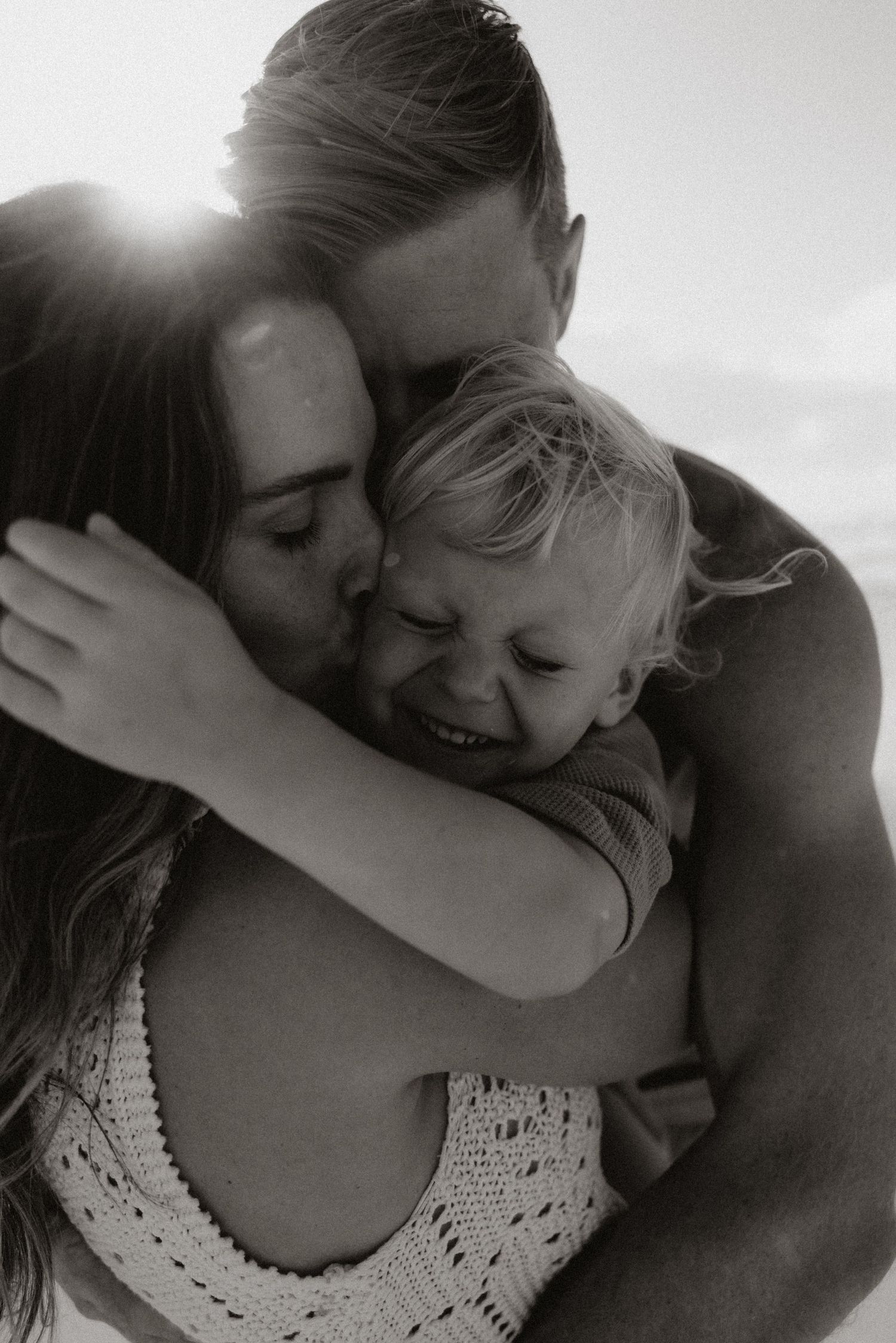 A tender black and white moment between a couple sharing an embrace.