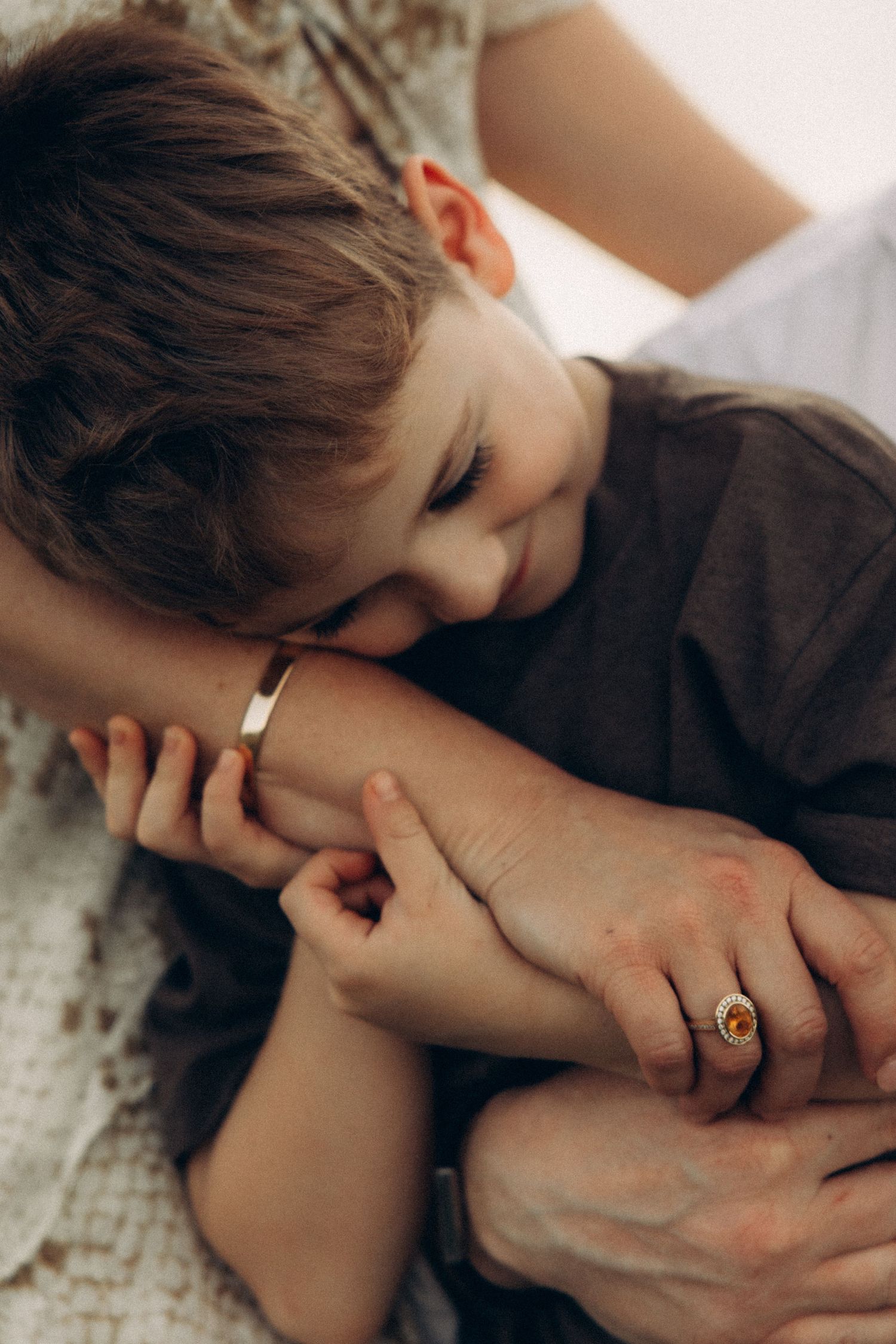 Intimate close-up shots showing gentle hand holding moments.