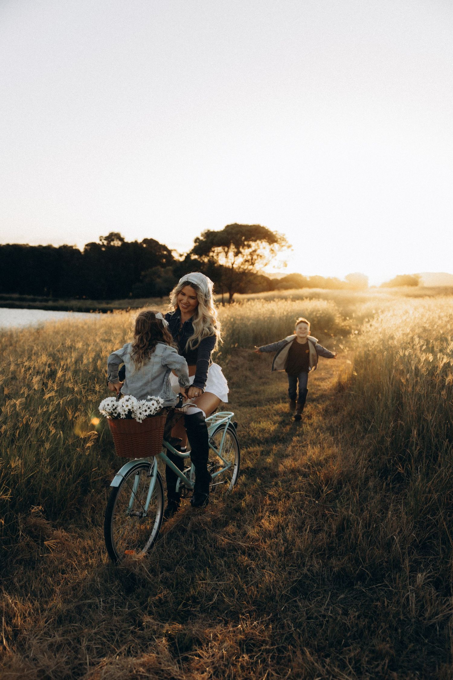 Wedding party walking through a golden field at sunset.
