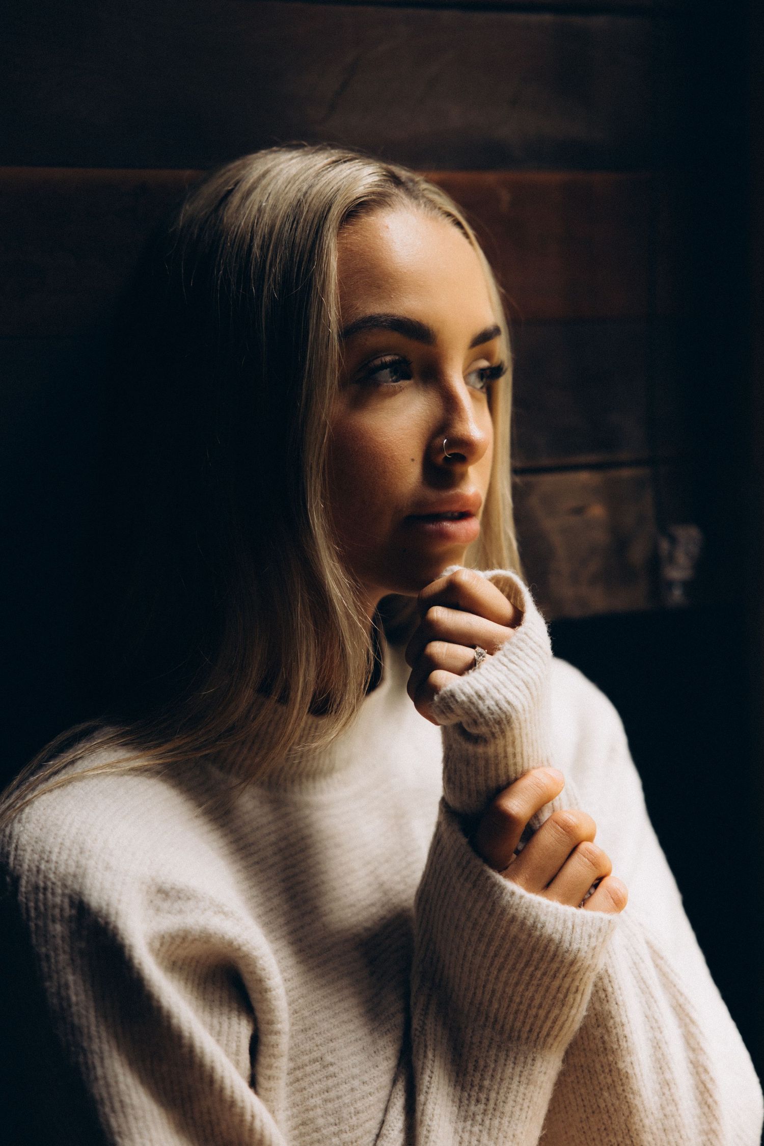 Atmospheric portrait sequence with contemplative poses in white sweater.