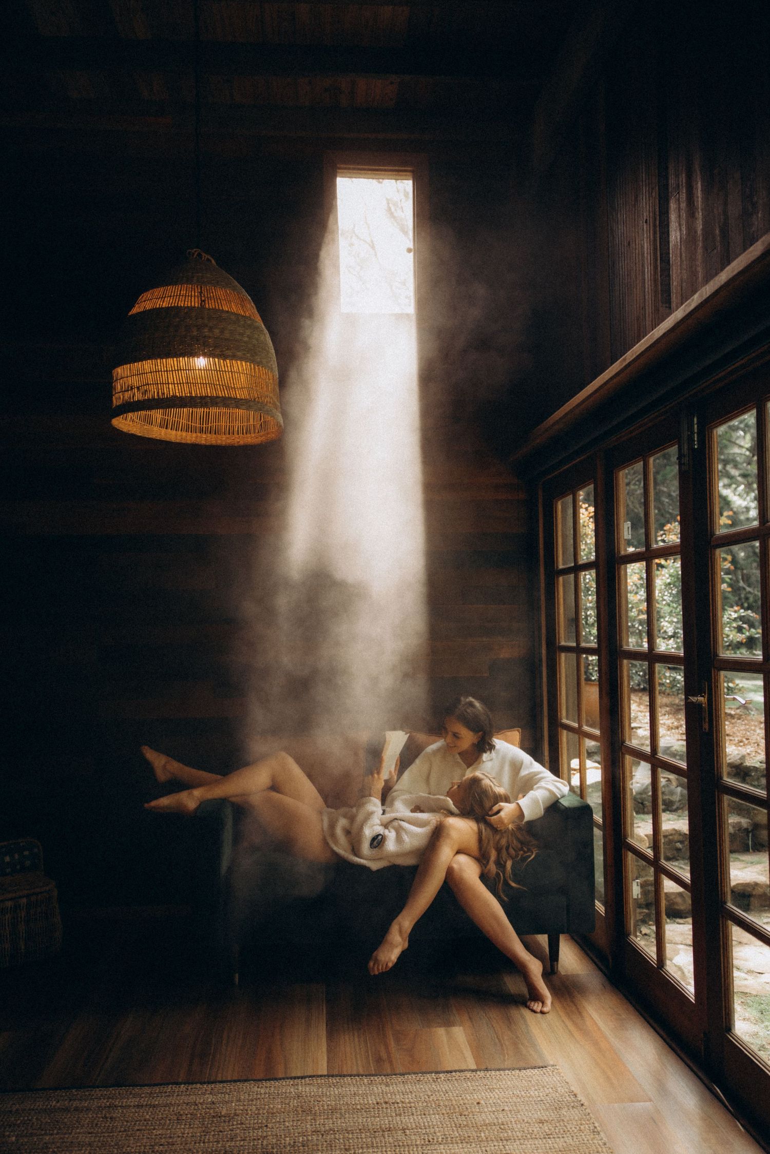 Artistic photo series showing a person floating in beams of sunlight in a rustic room.