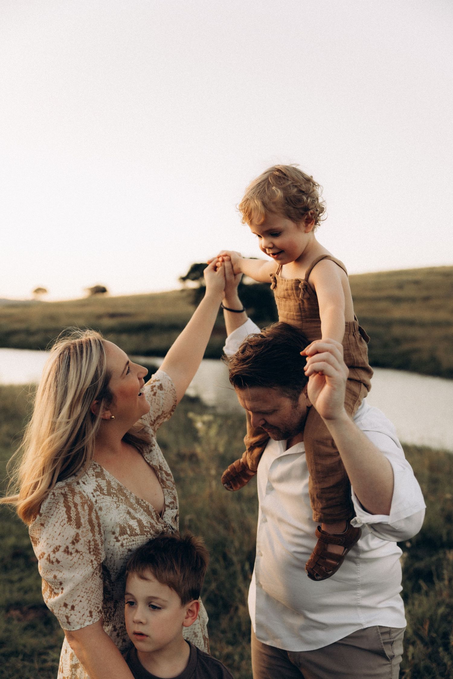Family lifestyle photos captured during golden hour by a lake.