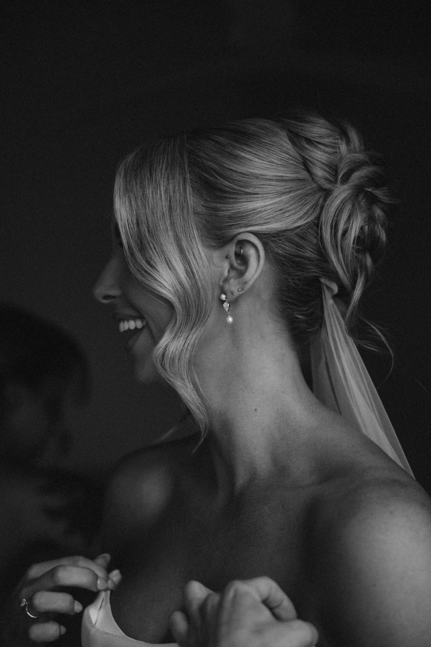 Close-up black and white portraits showing elegant bridal hairstyle details from different angles.