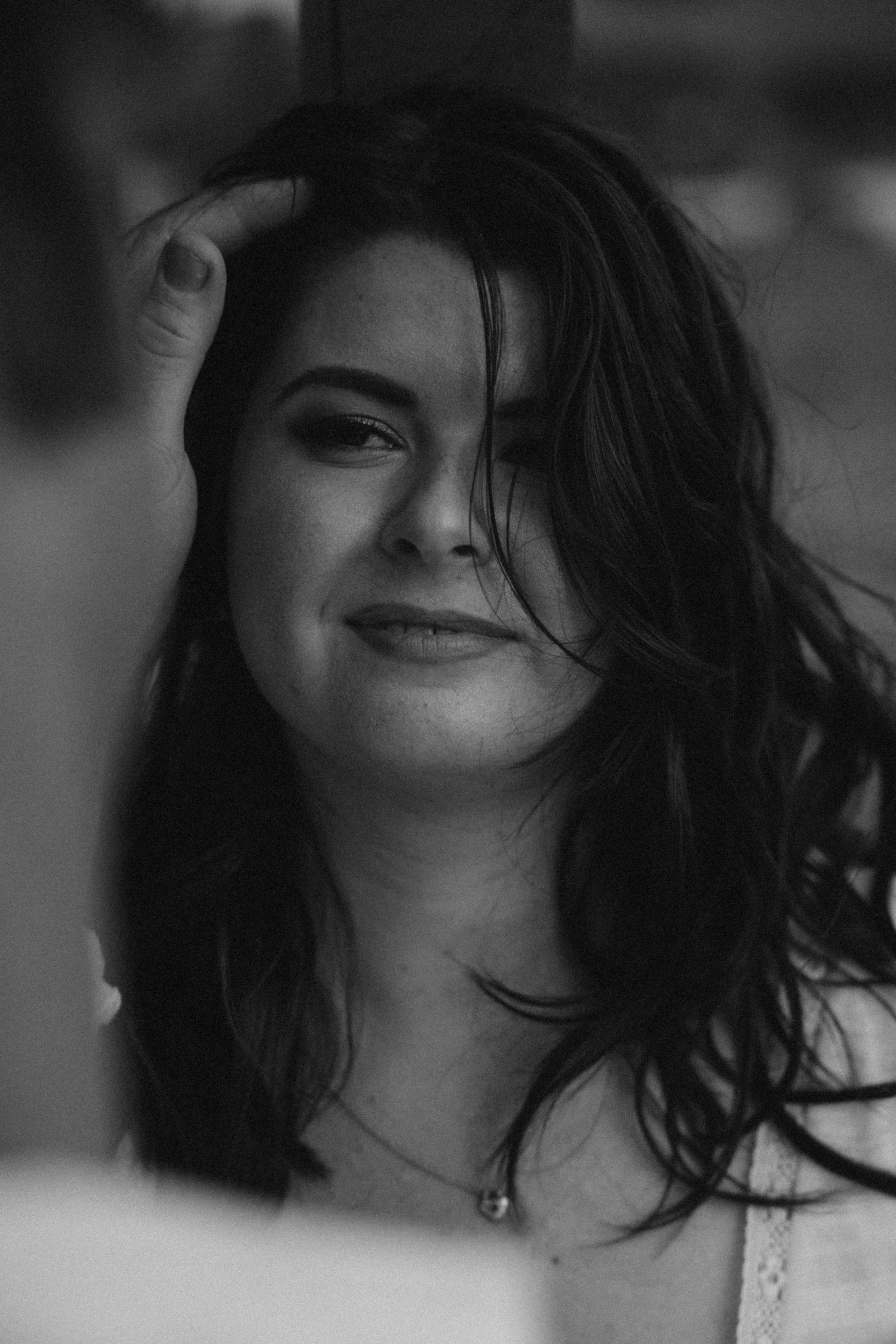 A black and white portrait showing natural expressions and windswept hair.
