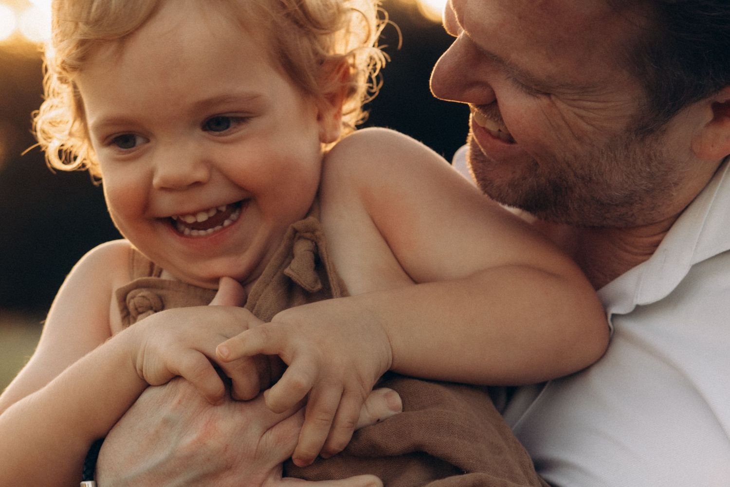 Intimate family portrait series with warm sunset lighting.