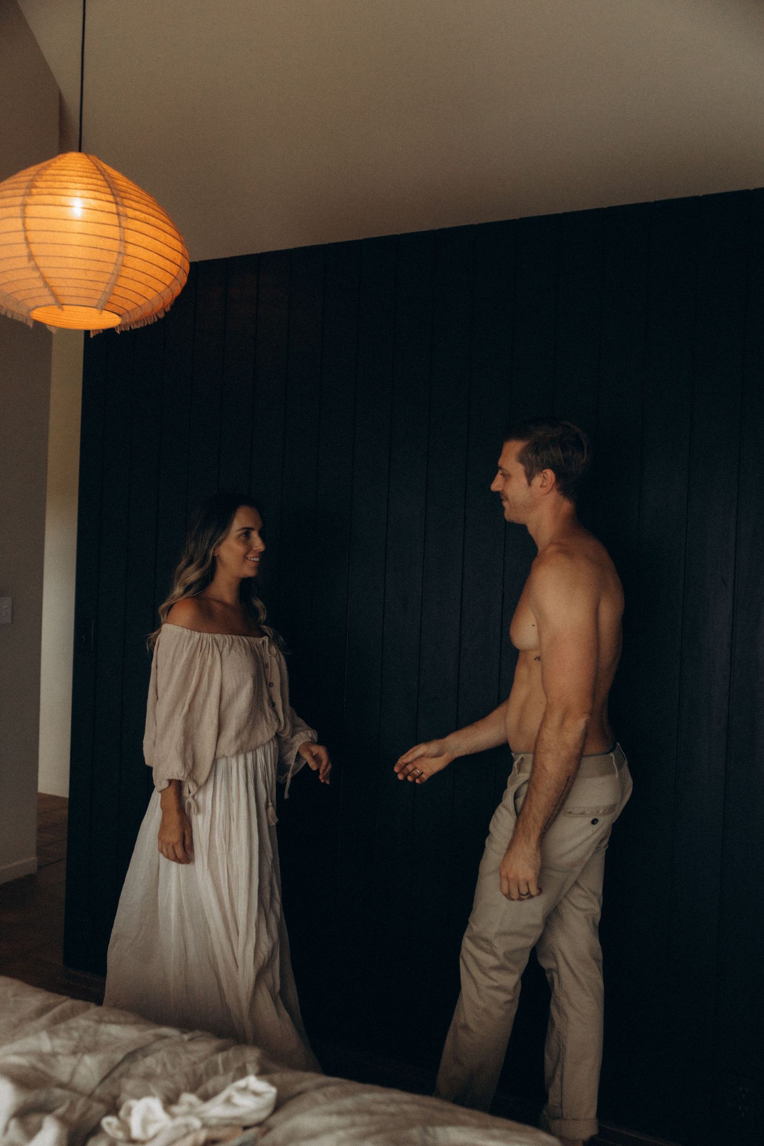 Interior scene with paper lantern lighting and two people in casual attire.