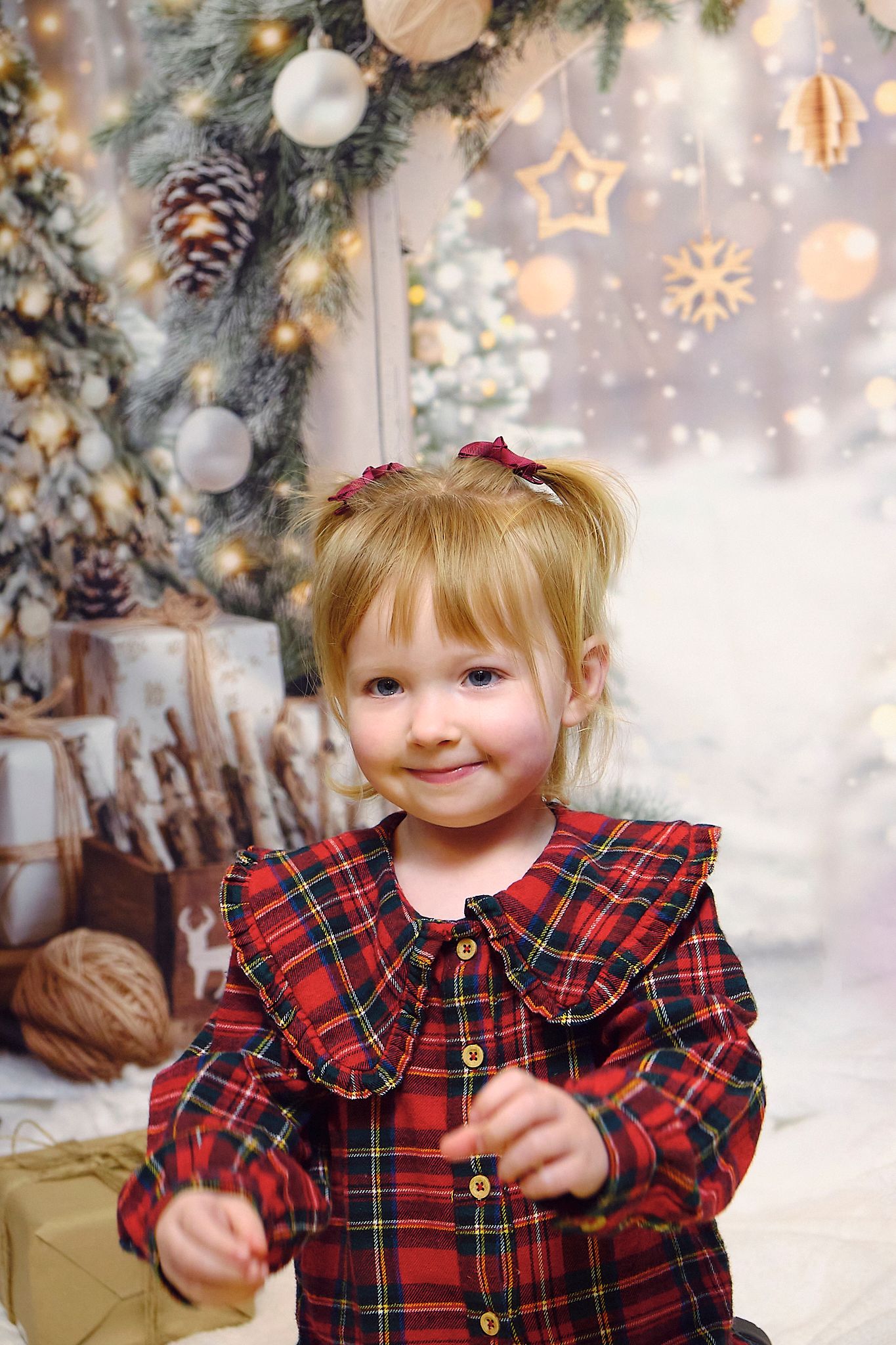 Child smiling, Christmas themed background.