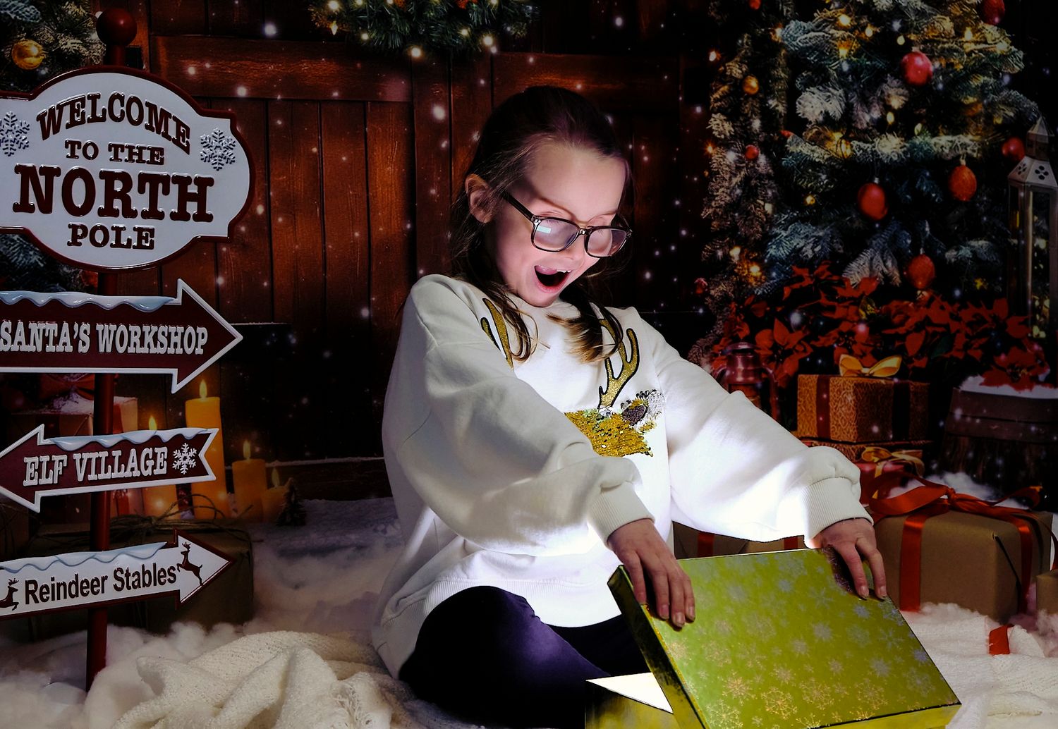 Child opening christmas gift bow with light shining out. Shocked expression. Christmas background.