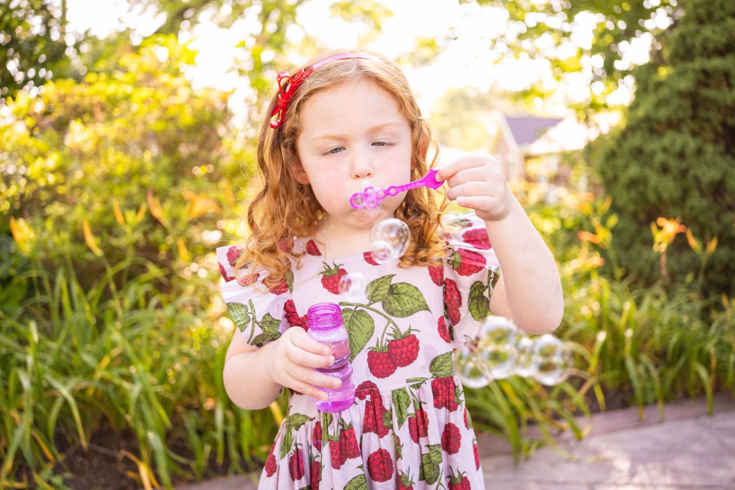 children photography session in downtown Bentonville Arkansas garden by the best portrait photographer in Northwest Arkansas.