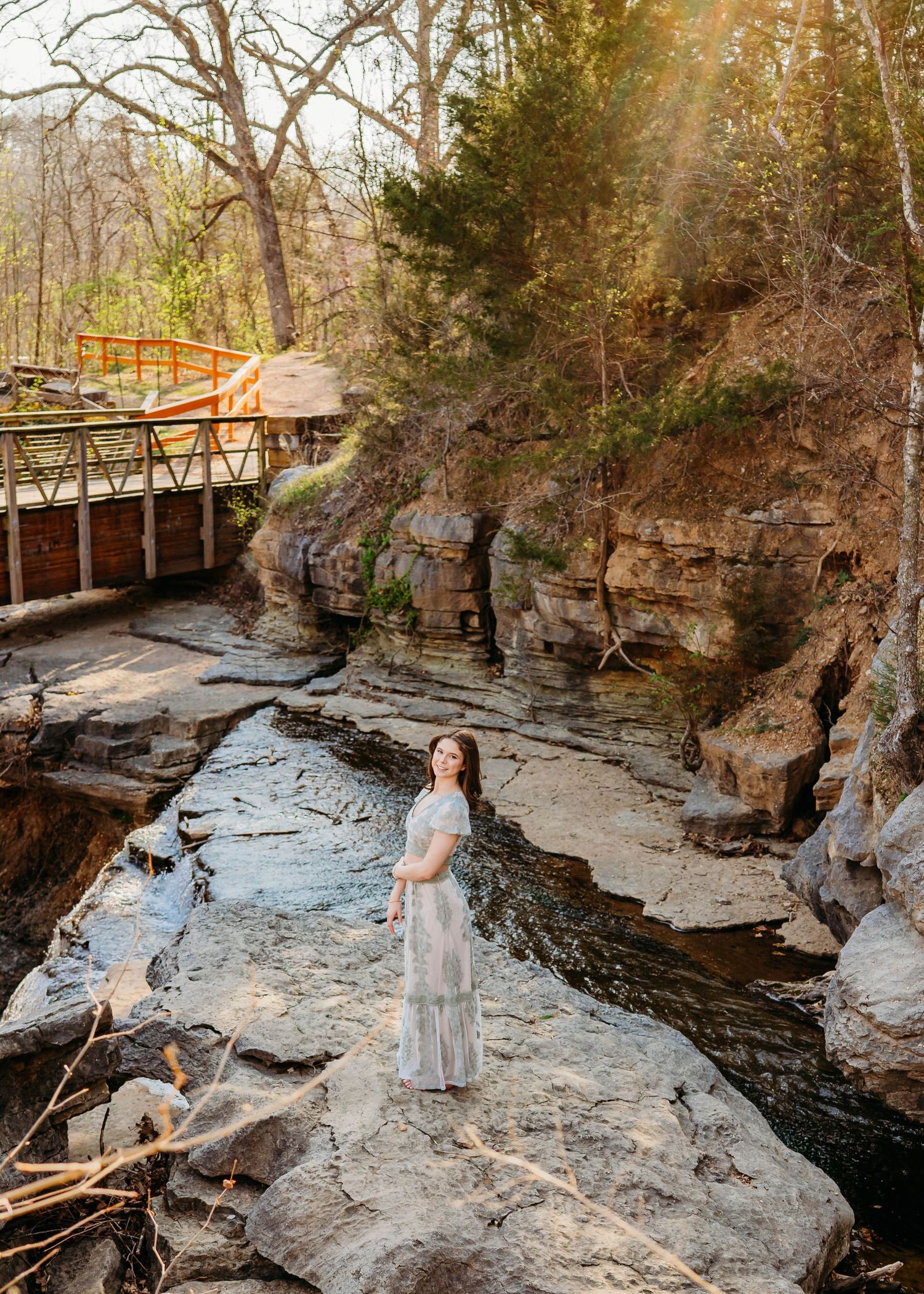 gorgeous senior photography session at beautiful waterfall in bella vista by the best Senior photographer in Northwest Arkansas